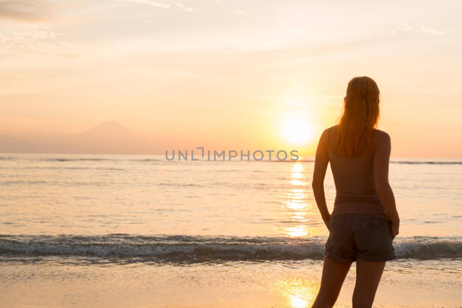 Woman watching sunset by nikitabuida