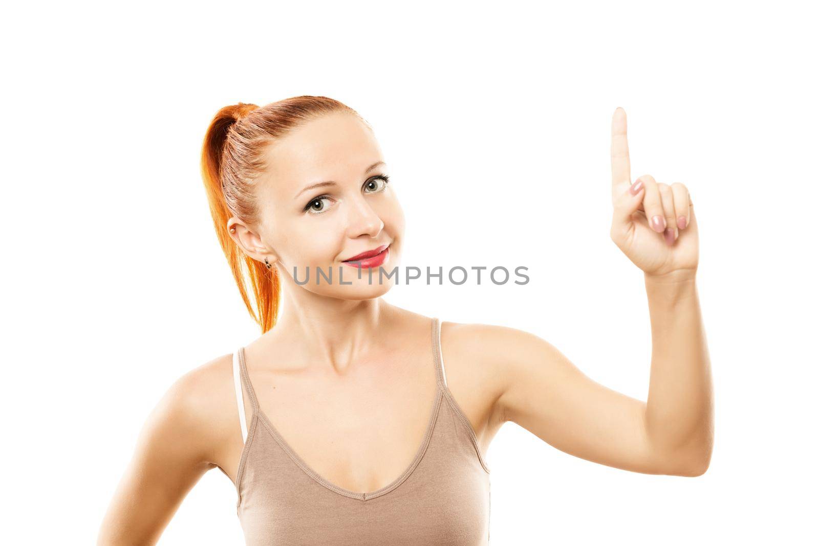 Young woman with healthy skin pointing up by nikitabuida