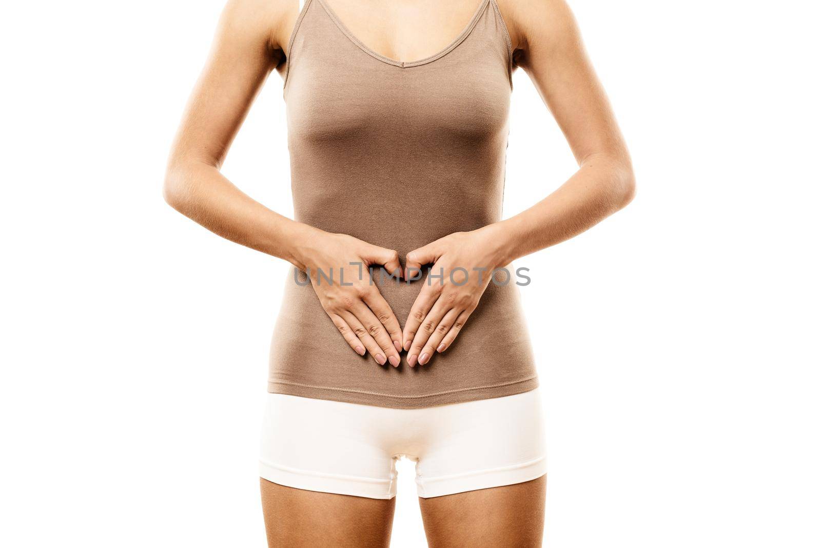 Slim Woman with hands on belly forming heart shape