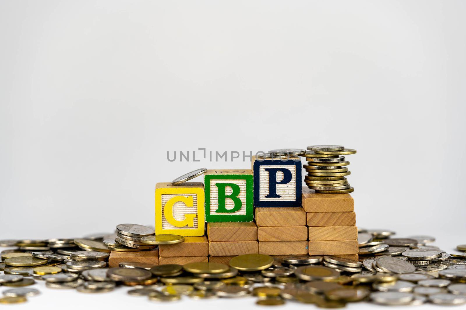 Forex GBP concept with wooden blocks and coins. Forx GBP letters on wooden blocks sorrounded with money by billroque