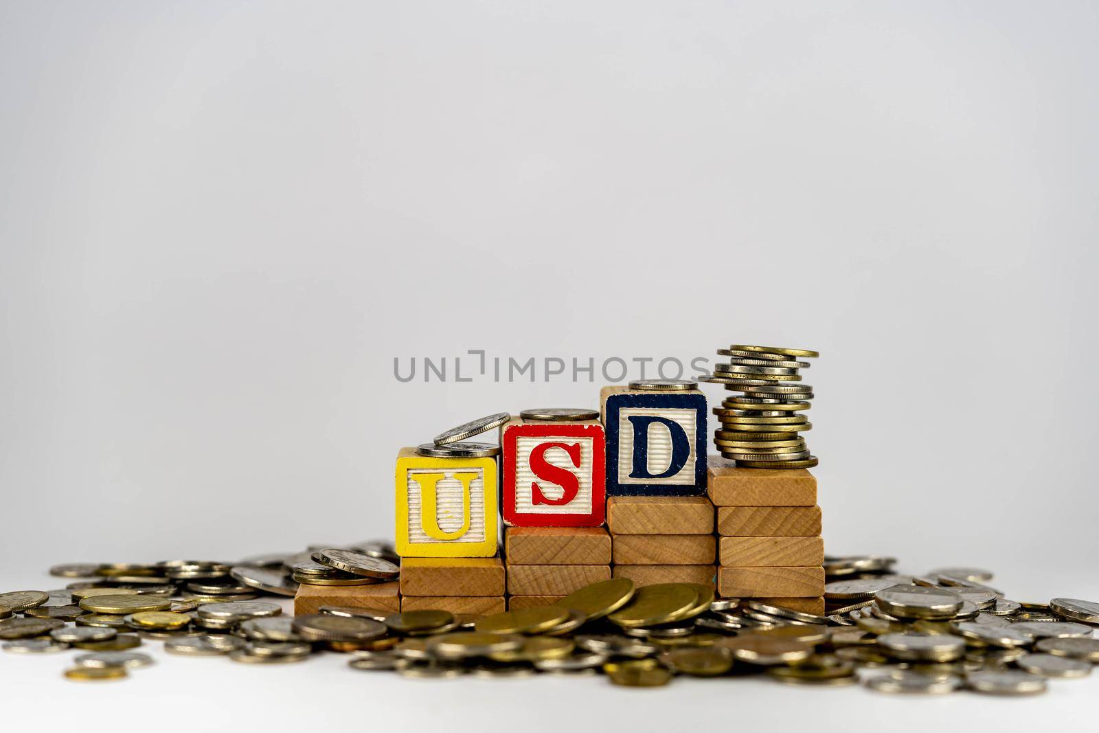 Forex USD concept with wooden blocks and coins. Forx USD letters on wooden blocks sorrounded with money