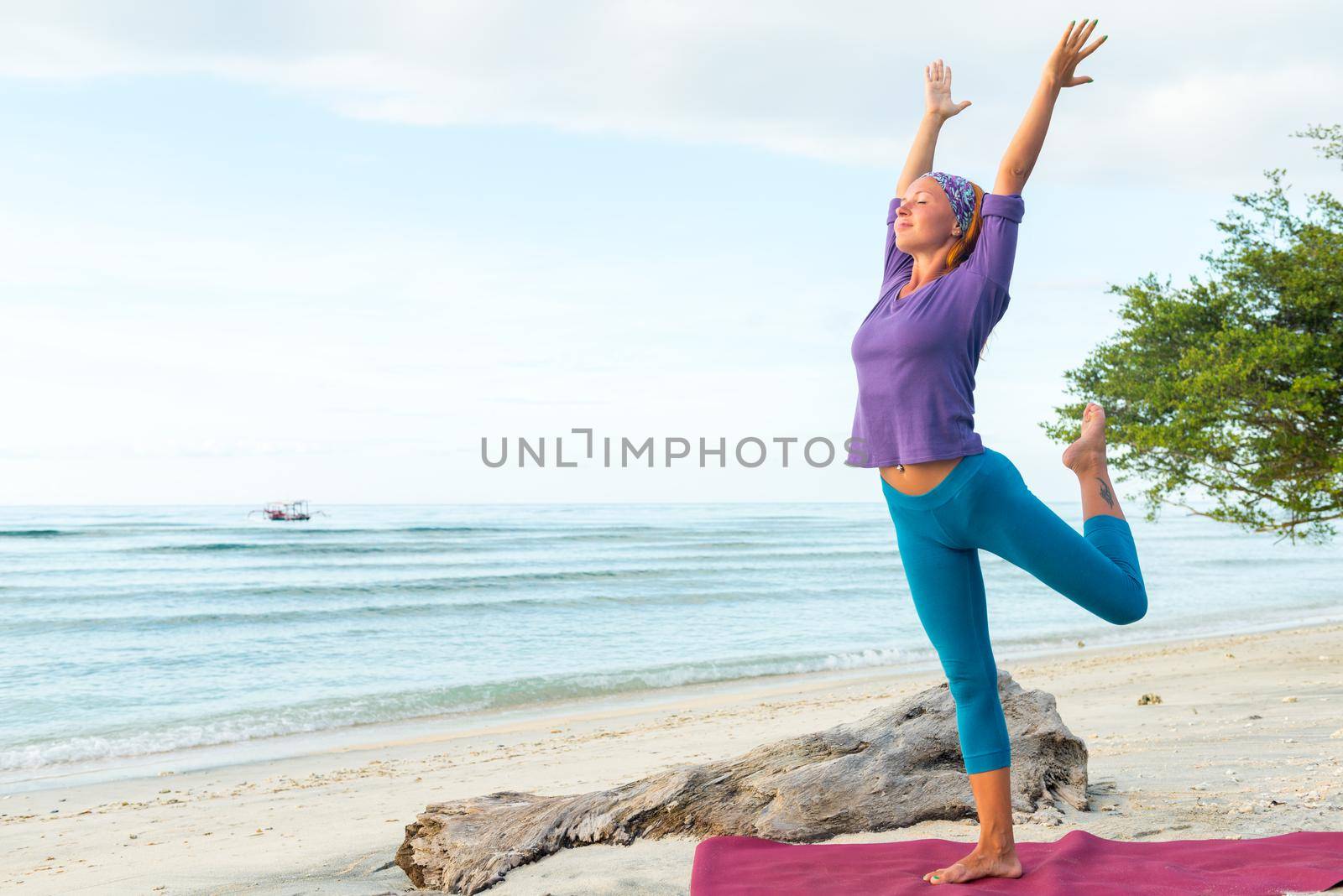 Young woman practicing yoga at exotic Bali location