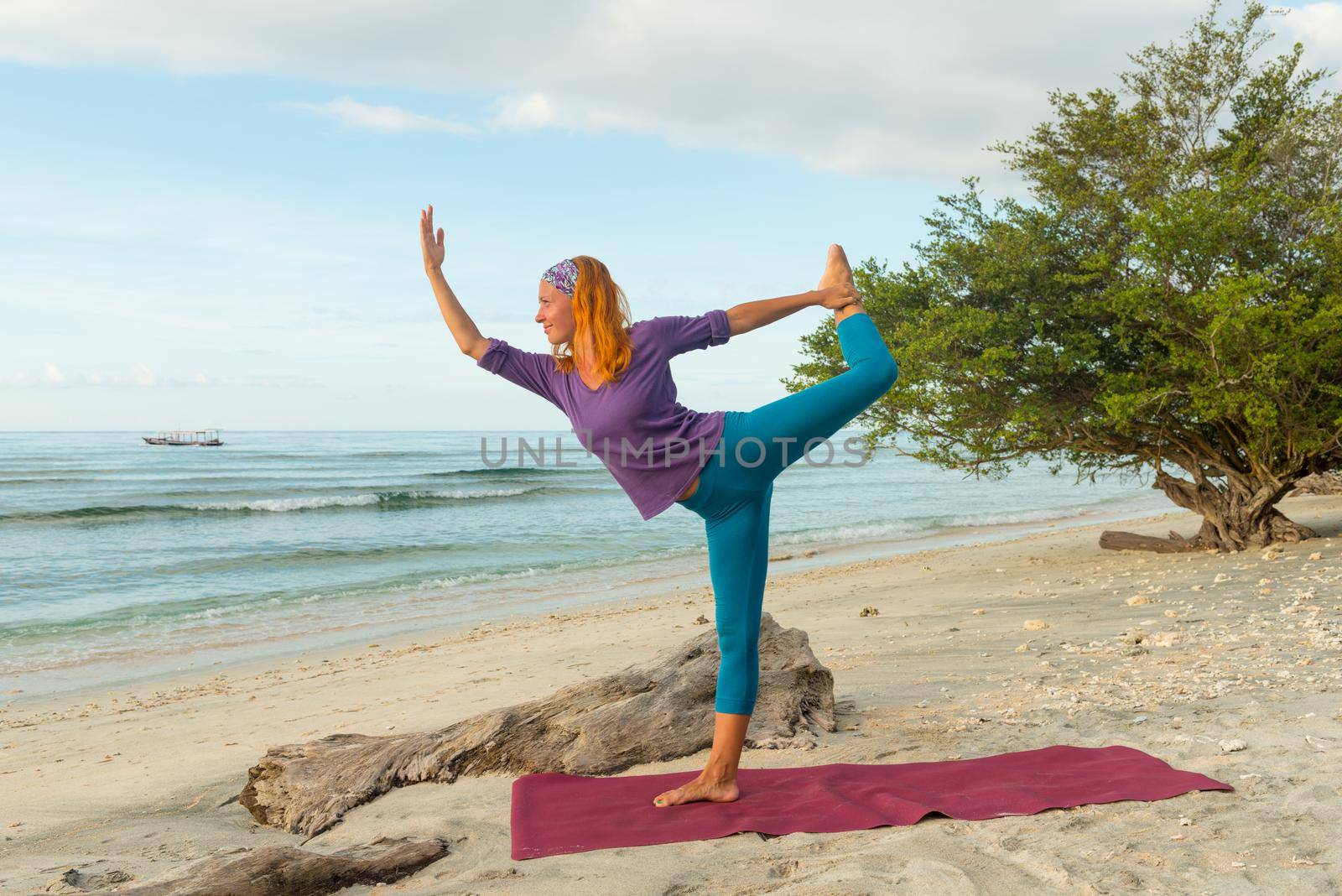 Young woman practicing yoga at exotic Bali location