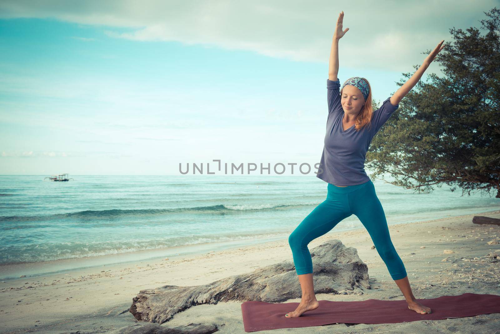 Young woman practicing yoga at exotic Bali location