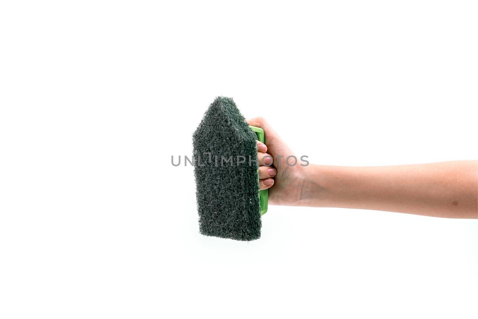 Close up human hand holding a green plastic scrubber isolated on white background. by wattanaphob