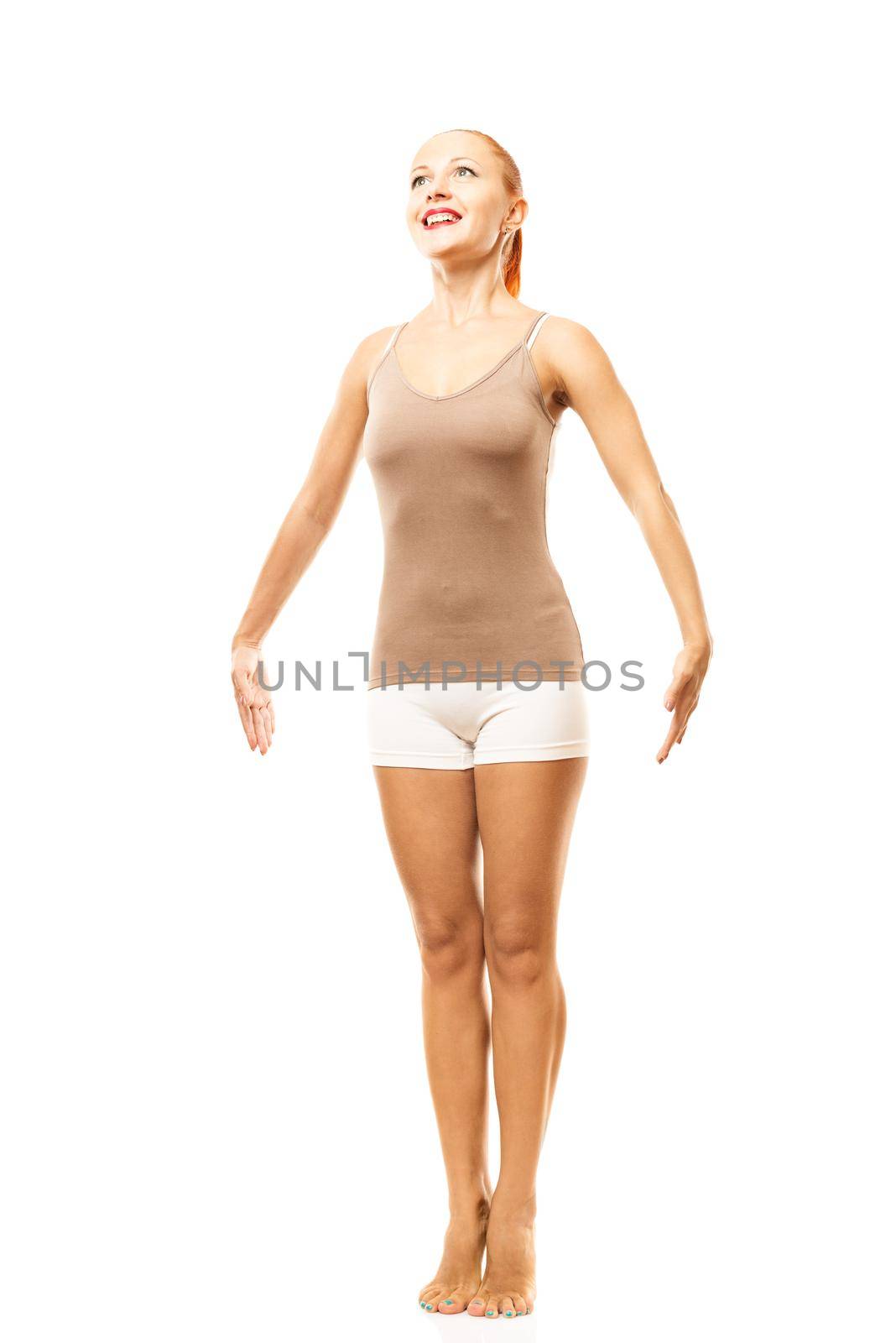 Young woman practicing yoga - standing on tiptoes