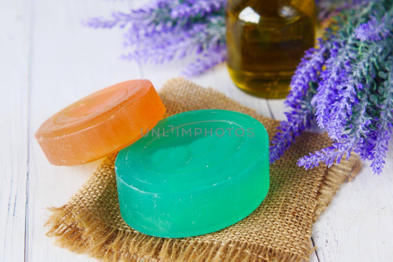 Homemade soap with dried lavender on table