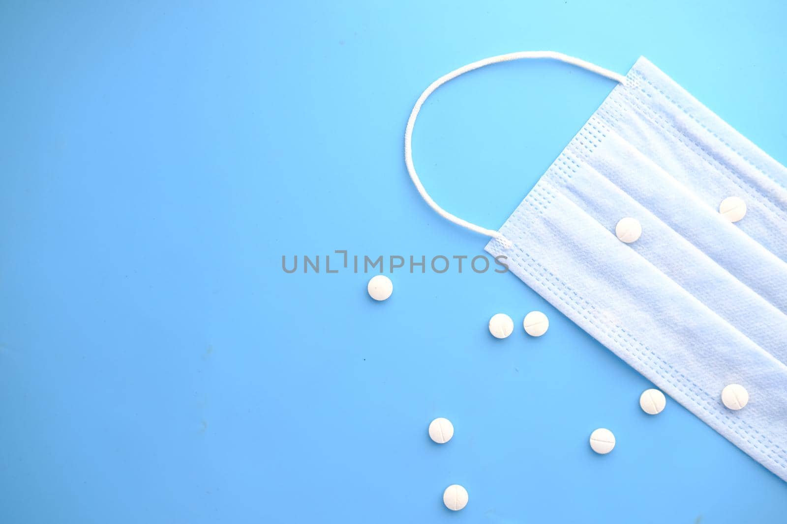 Close up of blue surgical masks on table.