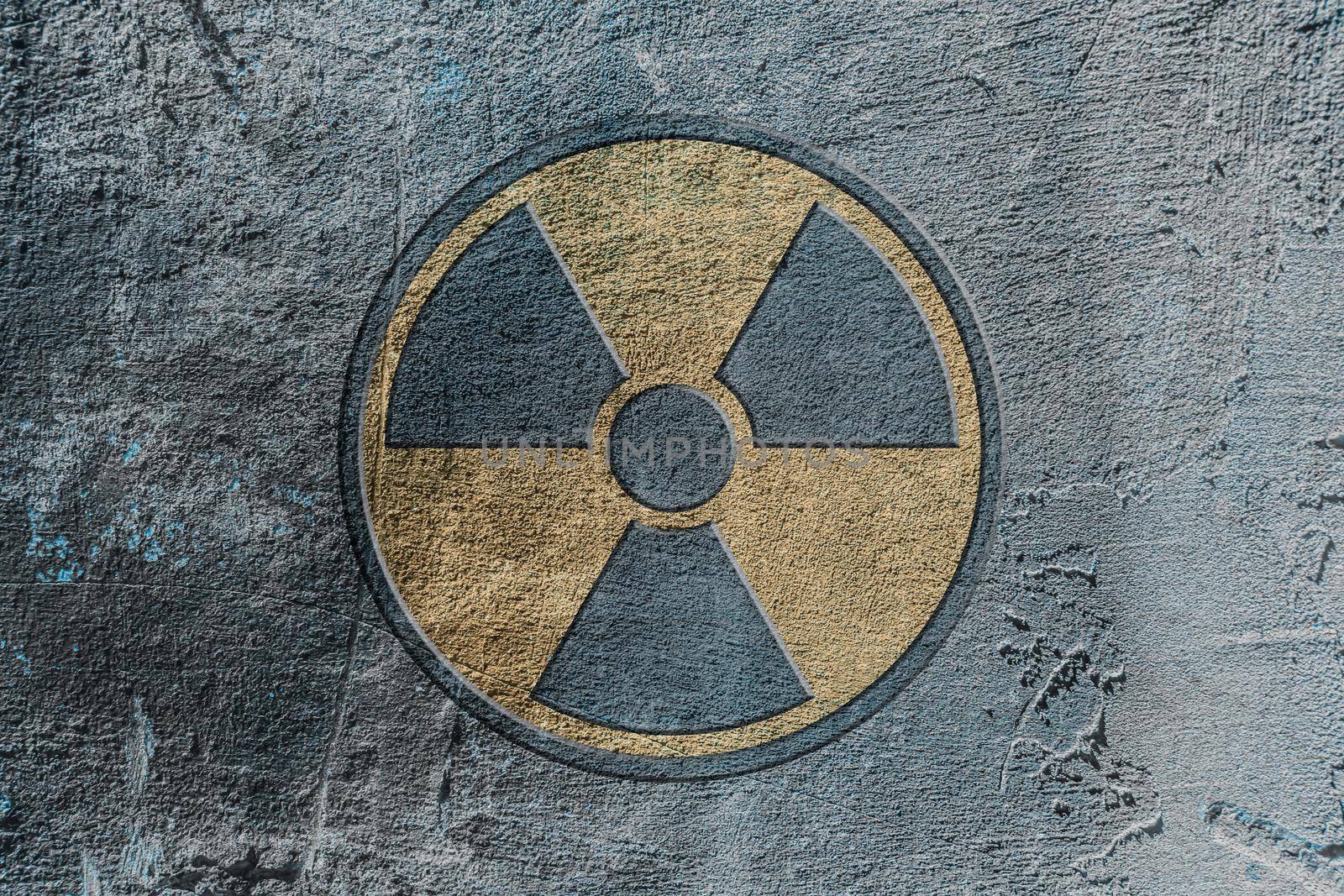 Radiation hazard warning sign depicted on a concrete wall