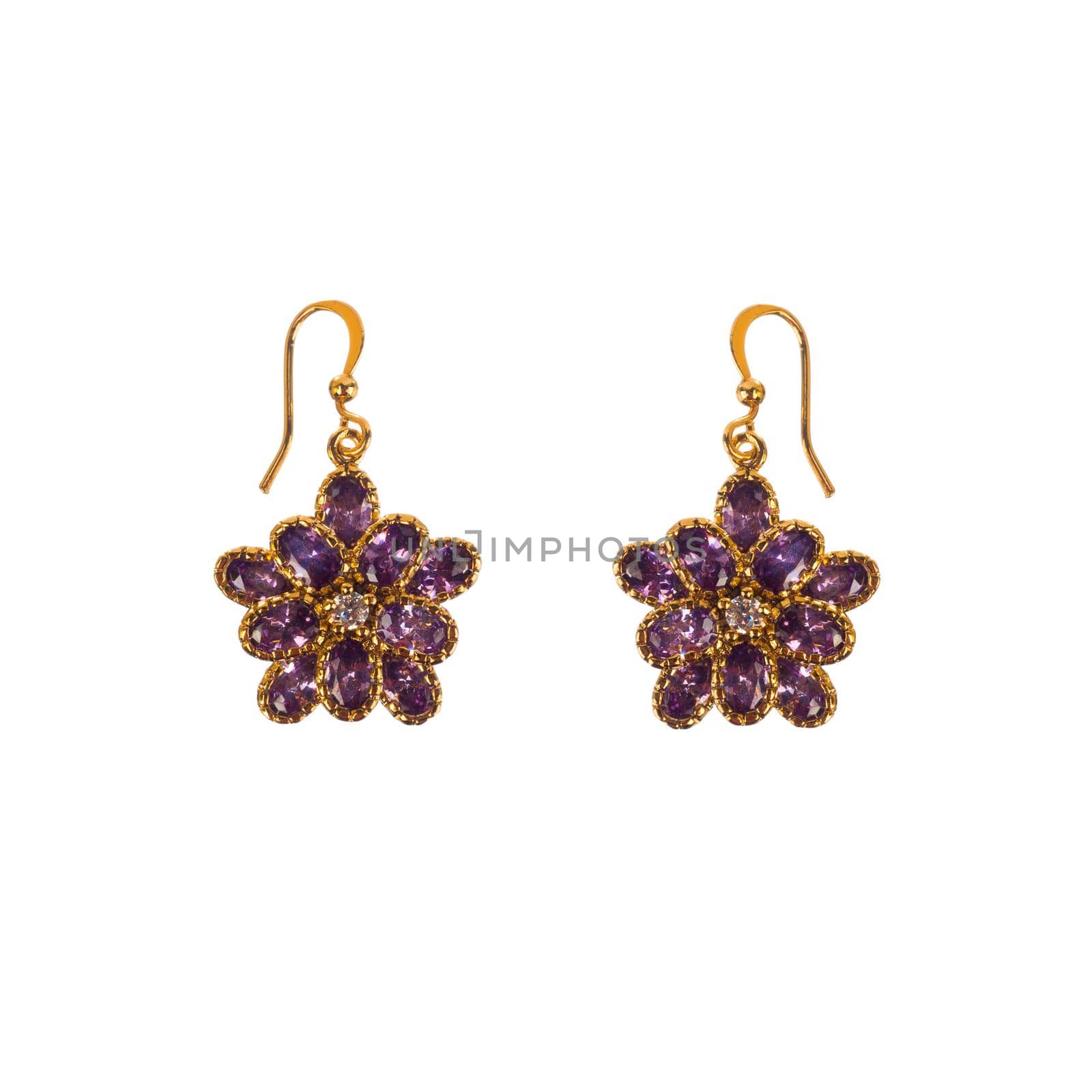 Golden earrings with purple gems isolated on white