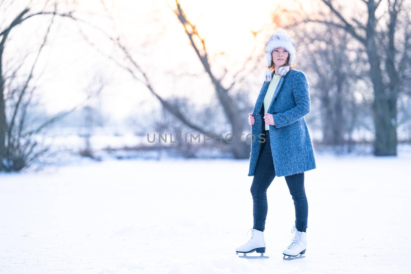 ice skating on a frozen pond in winter. banner by Edophoto