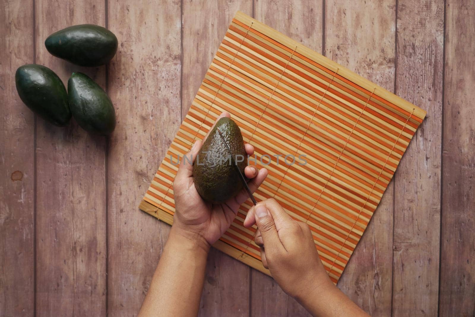 top view of slice of avocado on wooden table ,