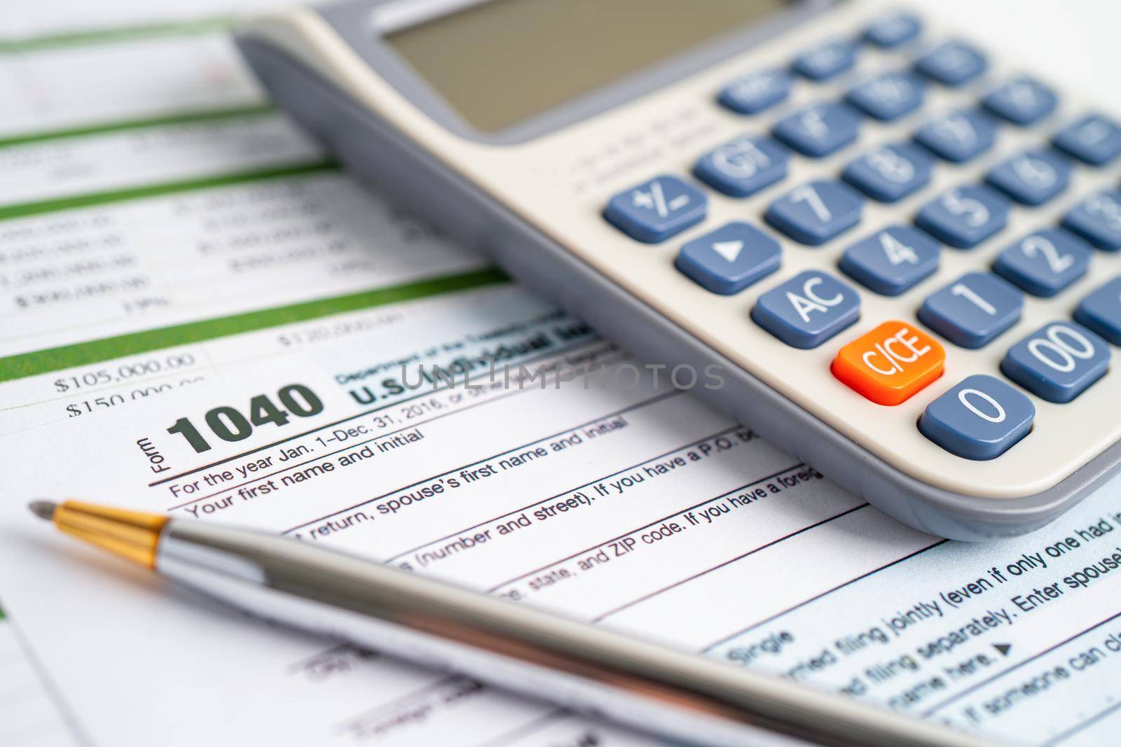 Tax Return form 1040 and dollar banknote, U.S. Individual Income. by pamai