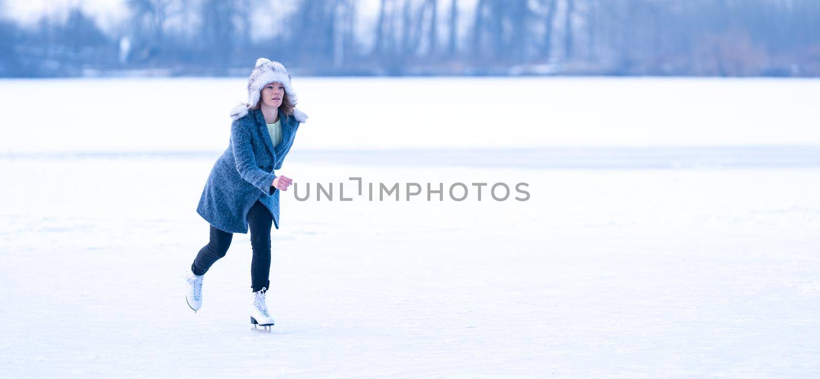 ice skating on a frozen pond in winter. banner by Edophoto