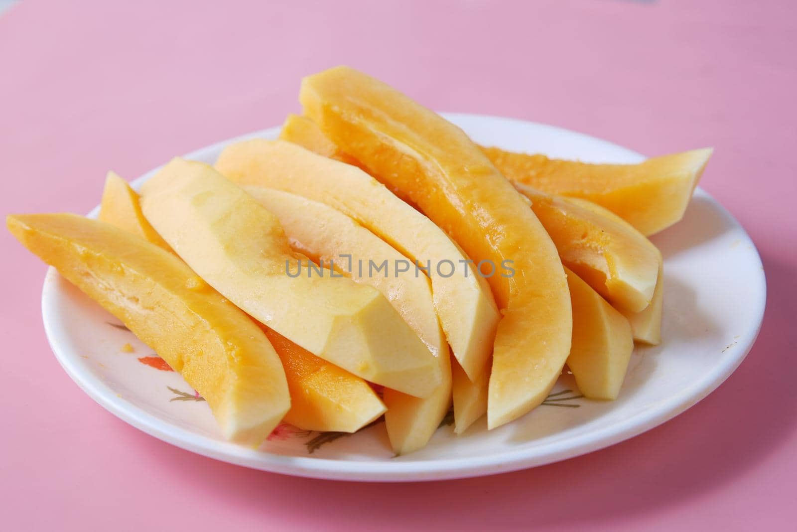 slice of papaya on white plate