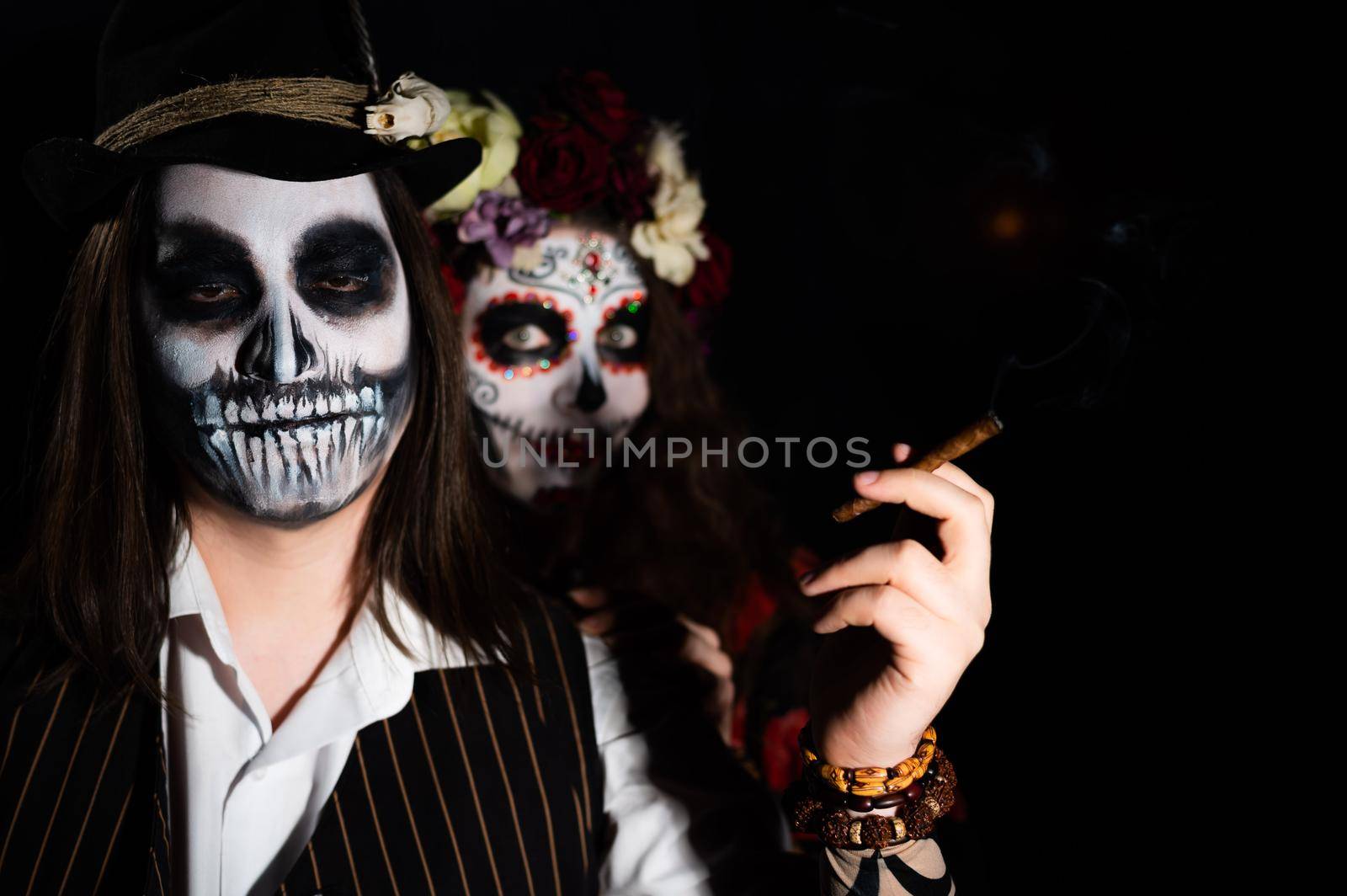 Woman in santa muerte costume and man in skeleton bodypainting for halloween. by mrwed54
