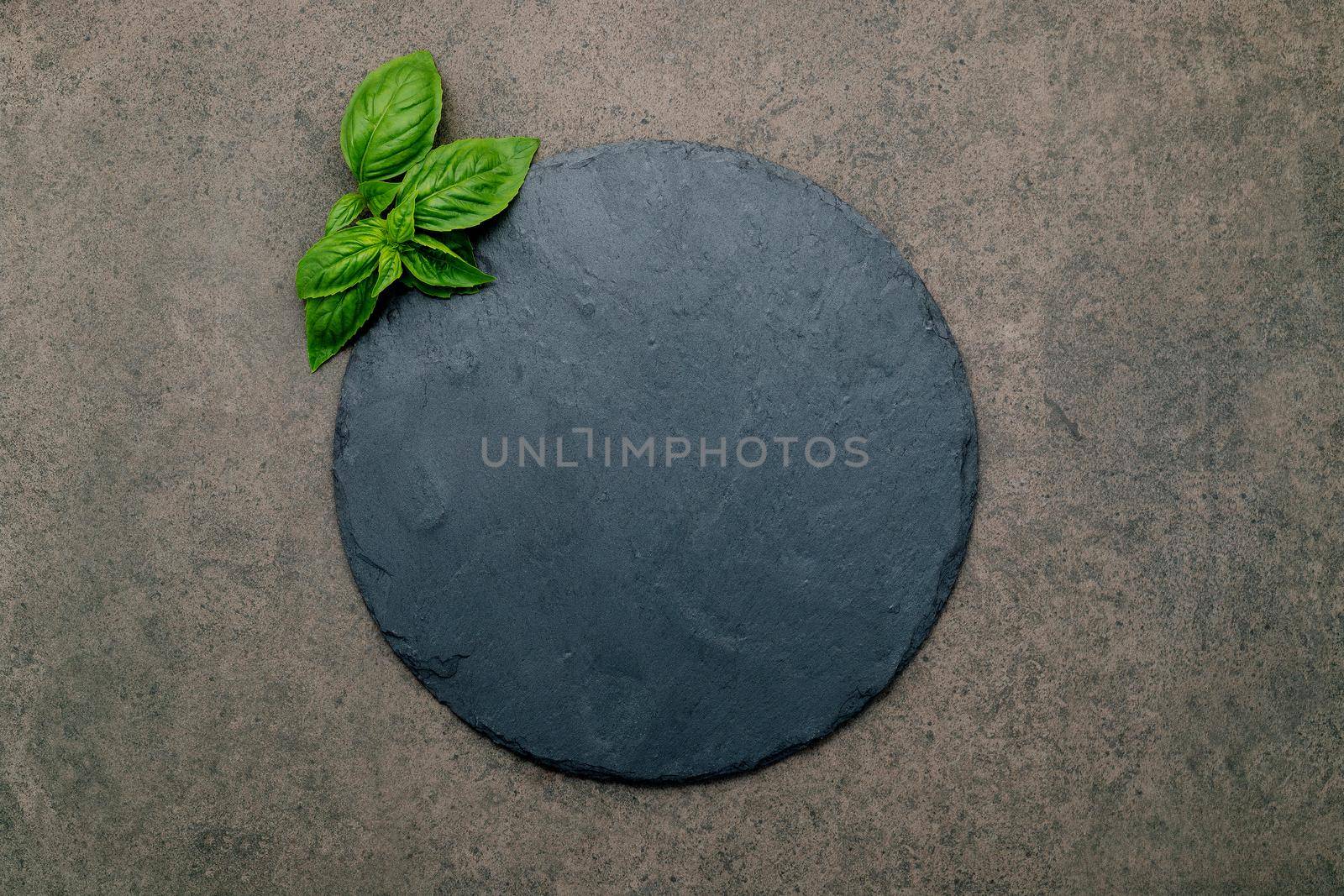 Empty pizza platter for homemade baking set up on dark concrete. Food recipe concept on dark stone background texture with copy space. 