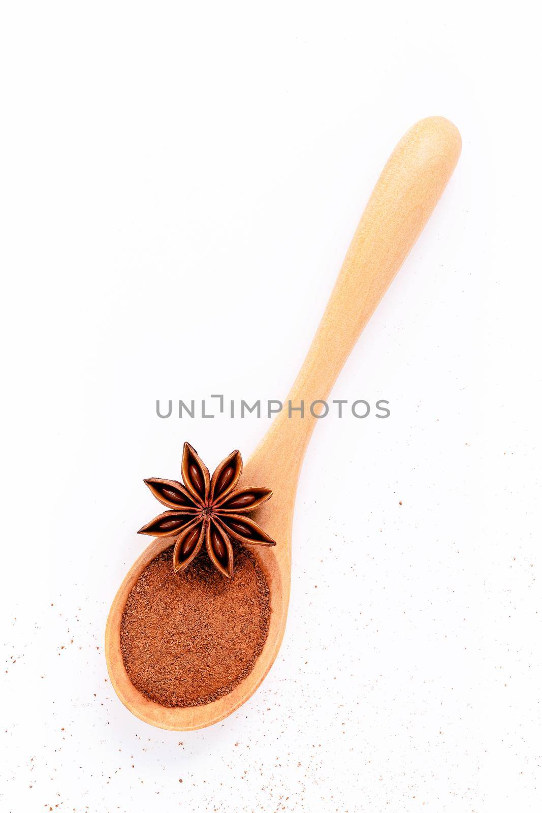 Close up chinese star anise in wooden spoon isolate on white background. Dried star anise spice fruits top view and copy space. by kerdkanno