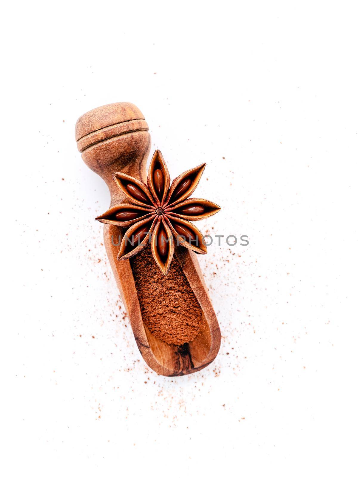 Close up chinese star anise in wooden scoop  isolate on white background. Dried star anise spice fruits top view and copy space.