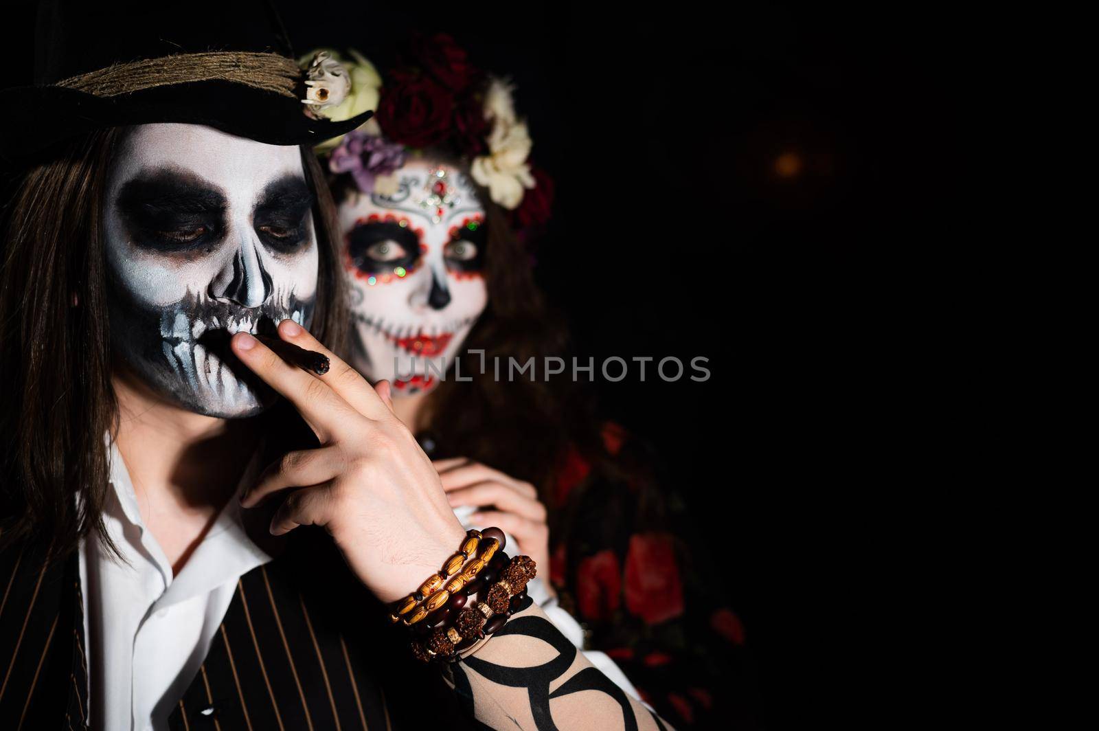 Man and woman in paired halloween costumes. Body art santa muerte and skeleton by mrwed54