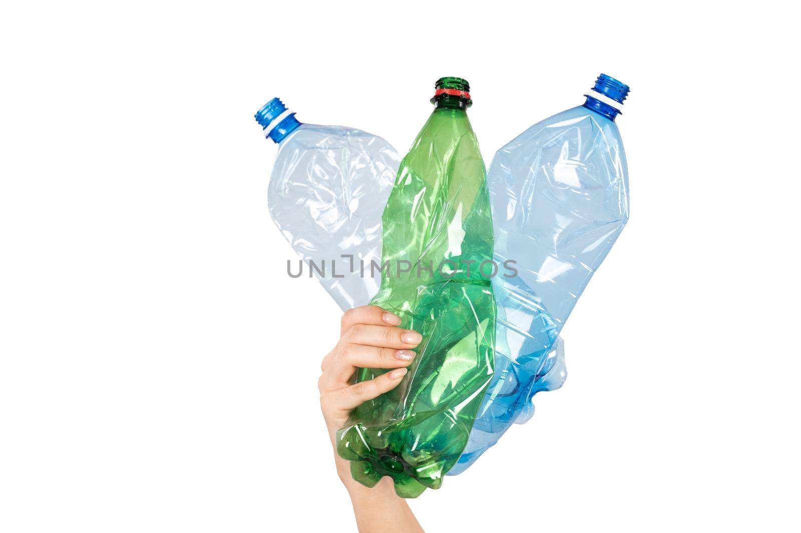 Close-up of a female hand holding plastic bottles on a white background. Isolated.