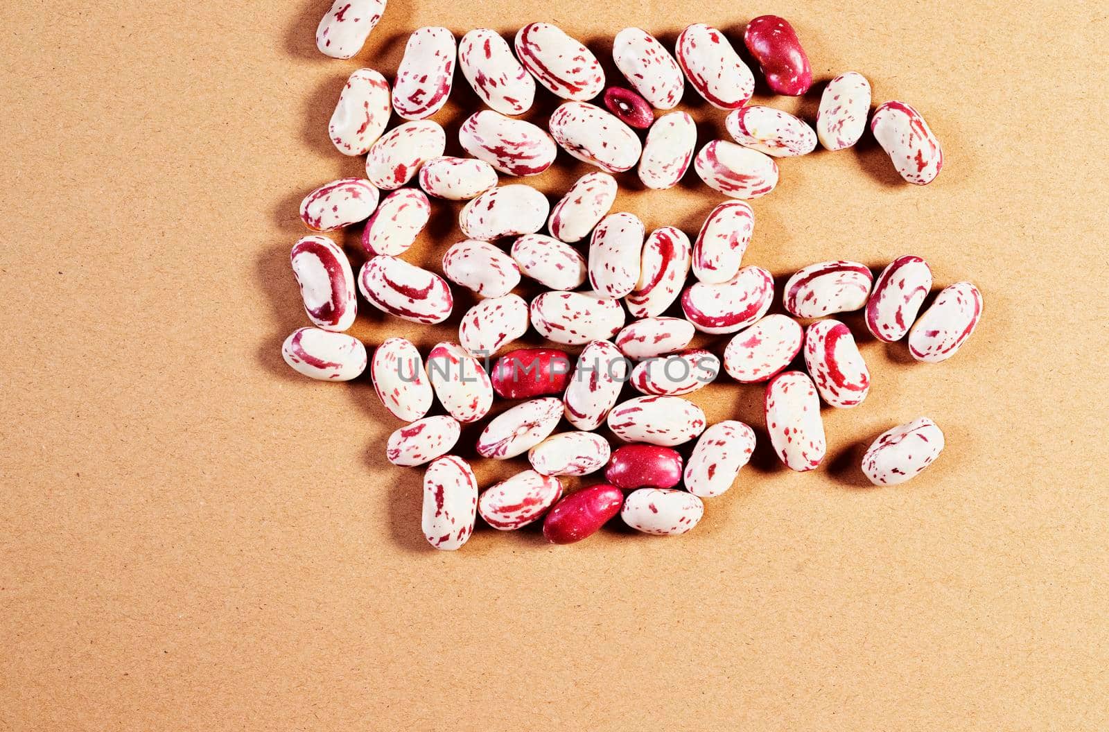 Fresh borlotti beans  on brown background , beans with red specks on creamy white background , common beans or pinto beans