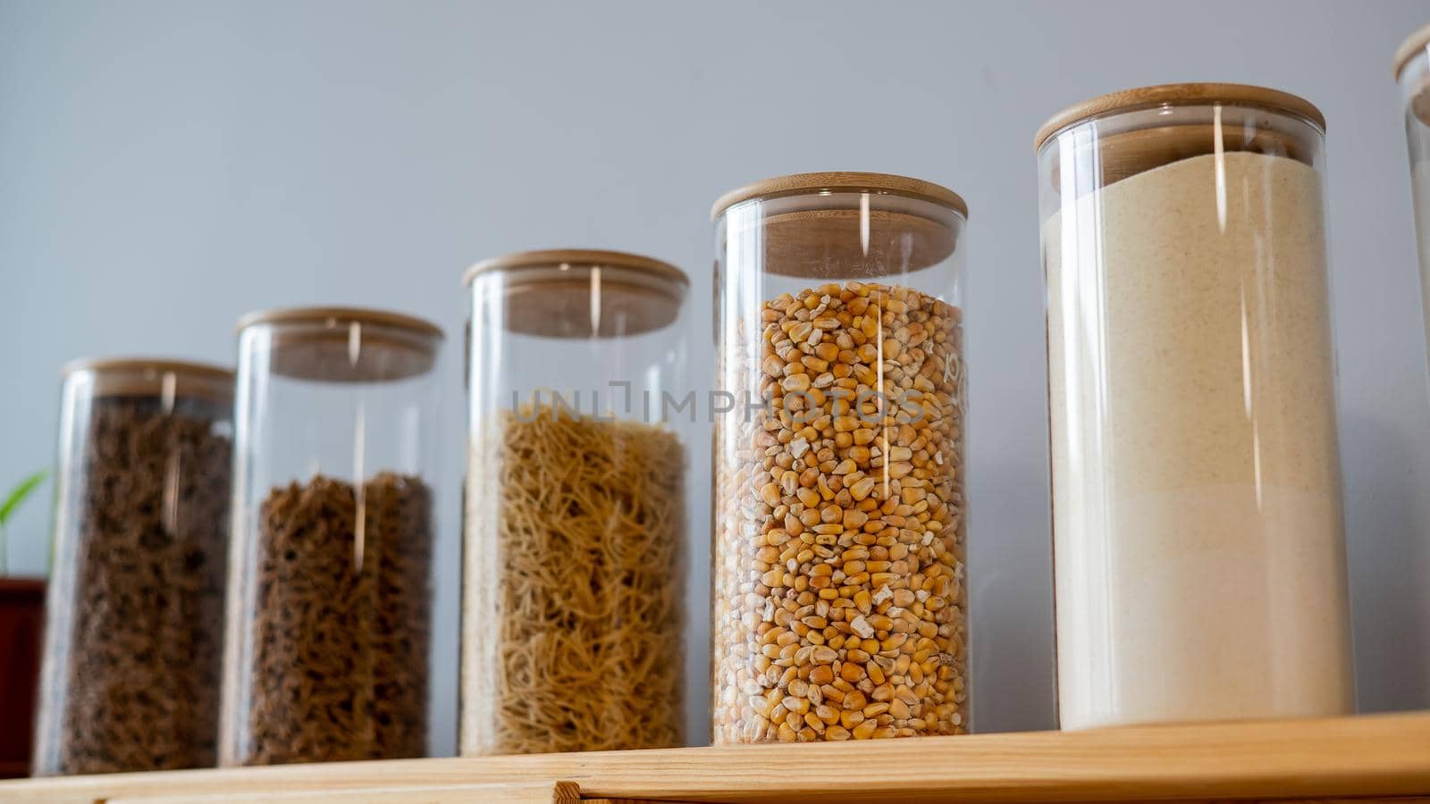 Glass jars with cereals in an eco friendly store. The concept of a grocery store without plastic disposable packaging.