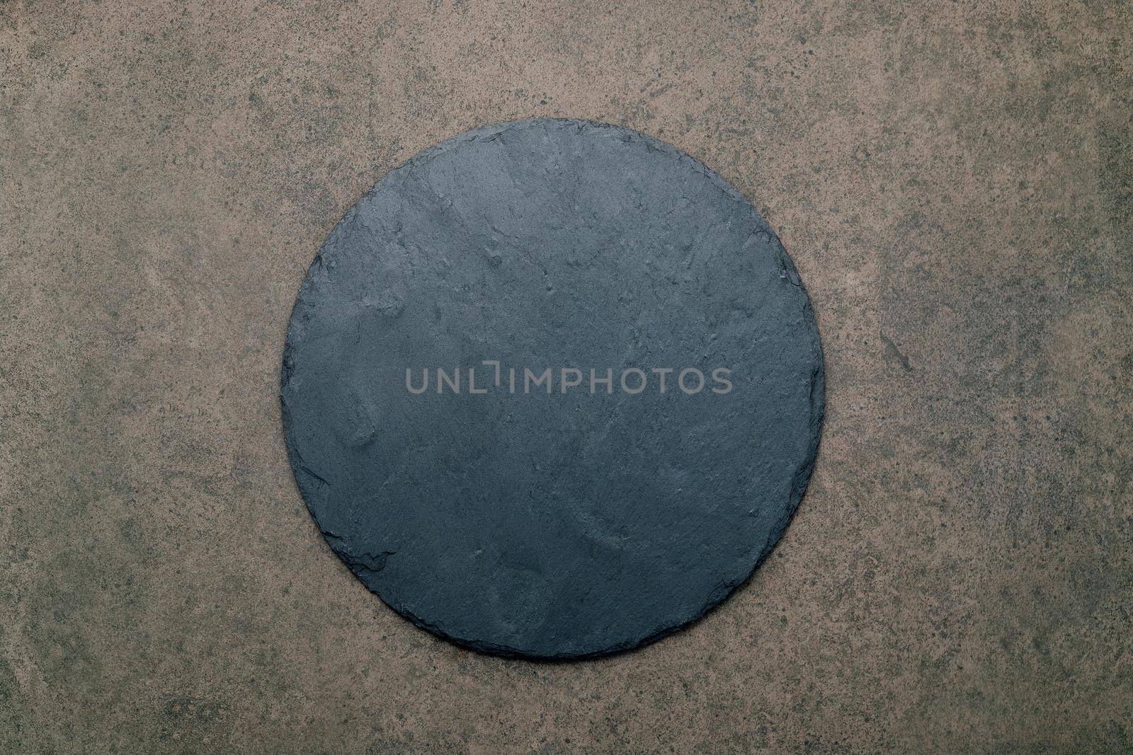Empty pizza platter for homemade baking set up on dark concrete. Food recipe concept on dark stone background texture with copy space.  by kerdkanno