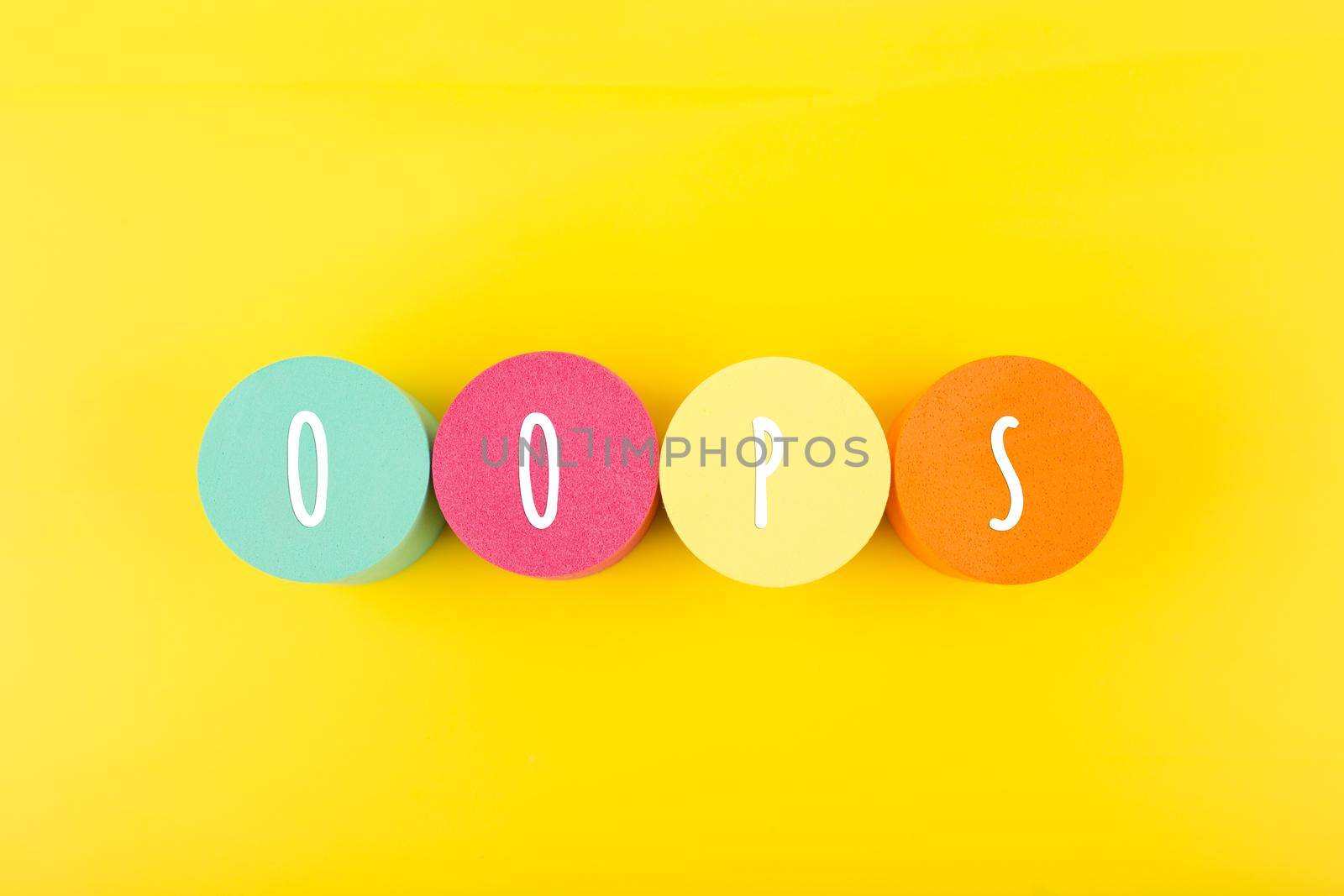Word oops written on colorful round geometric against yellow background. Trendy minimal concept of emotions expression or excitement