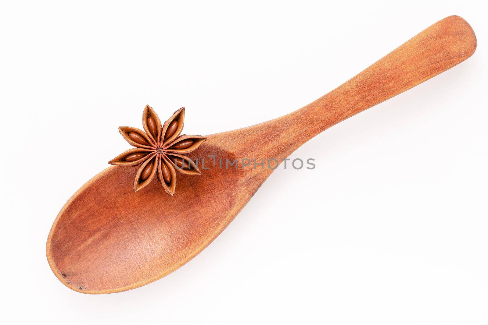 Close up chinese star anise in wooden spoon isolate on white background. Dried star anise spice fruits top view and copy space. by kerdkanno