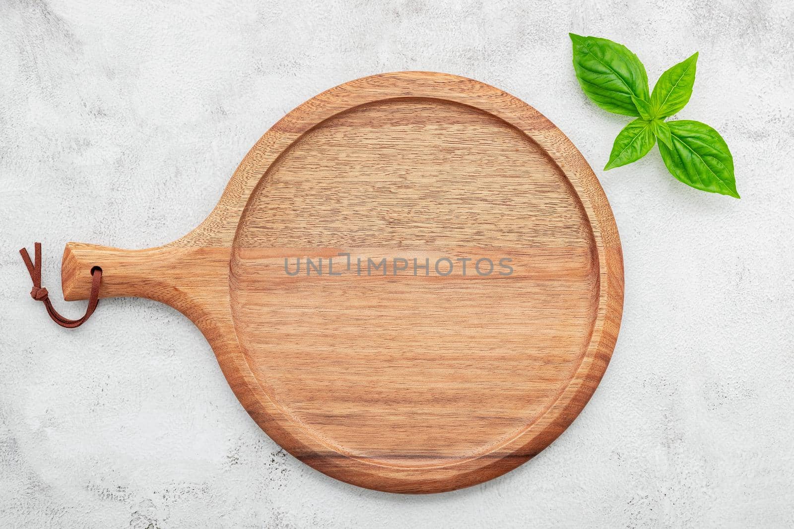 Empty wooden pizza platter set up on white concrete. Pizza tray on white concrete background flat lay and copy space.