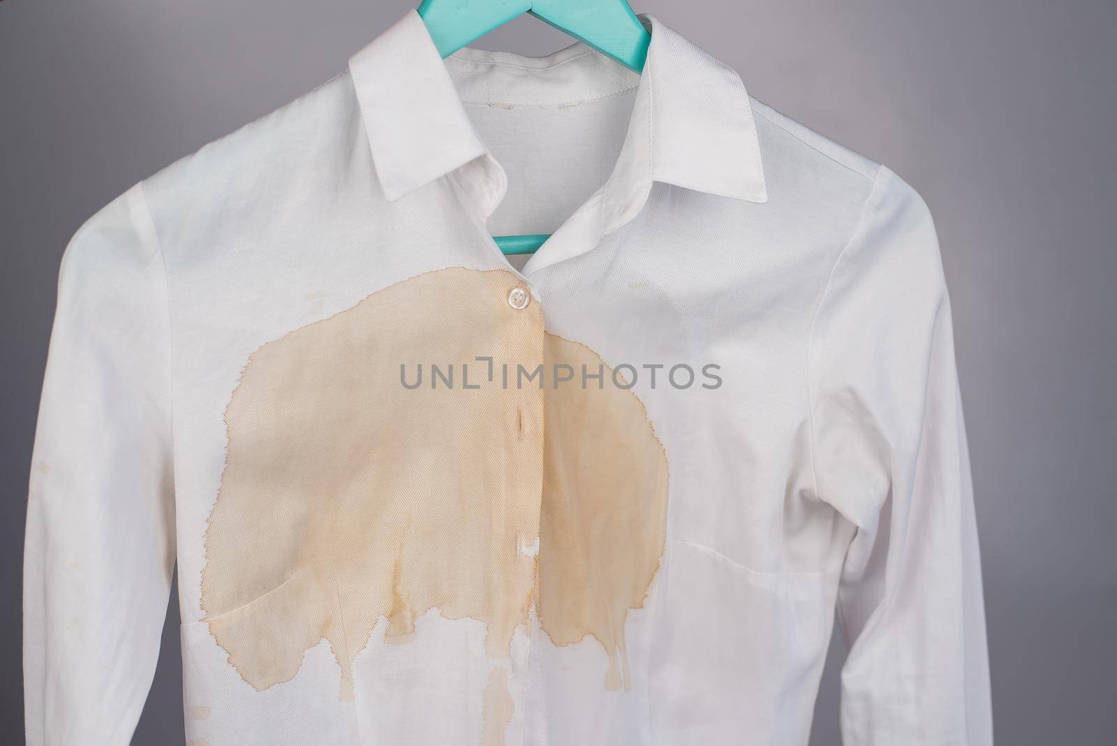 Women's office white shirt with a stain of coffee on a white background. by mrwed54