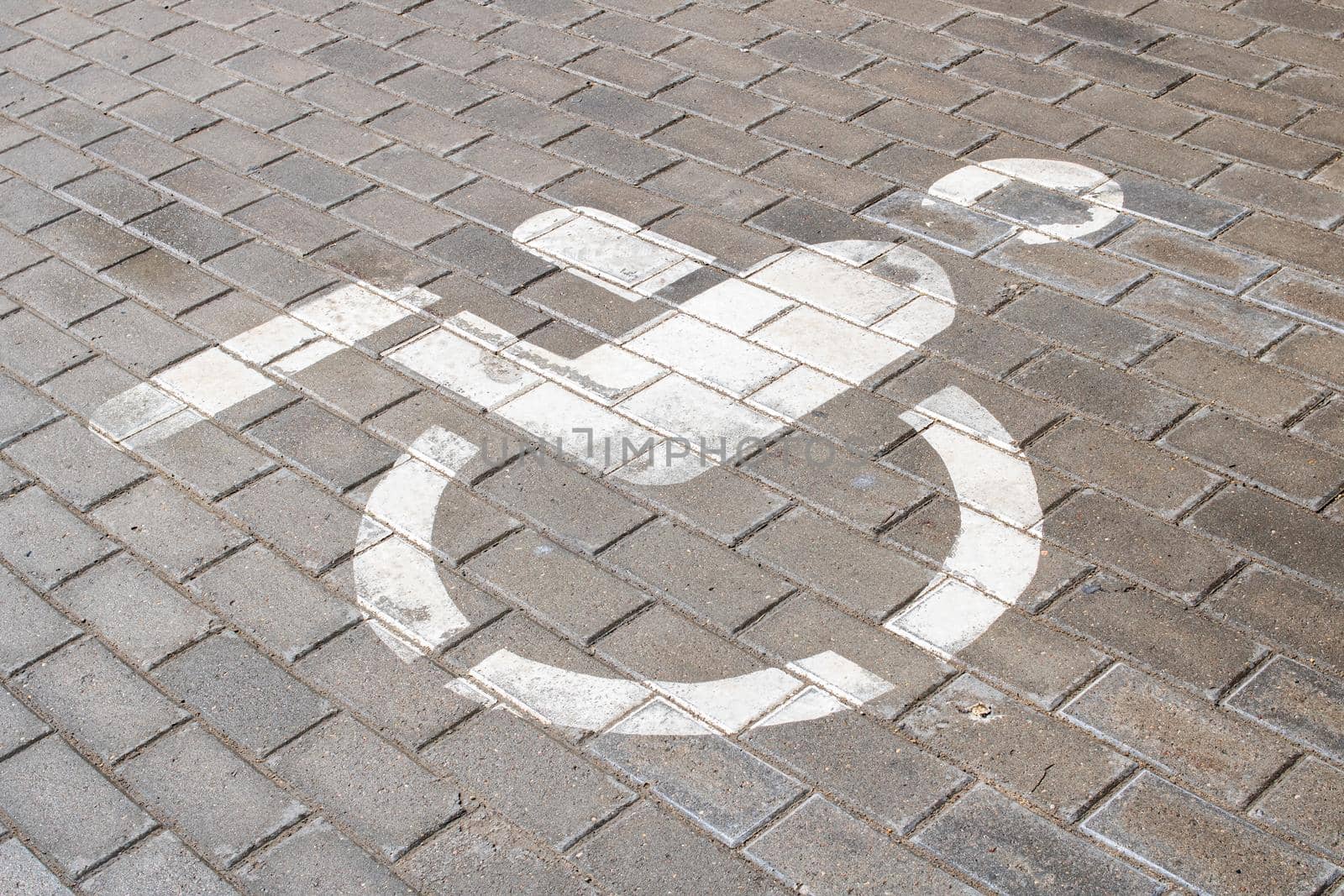 Disabled parking sign in the parking lot close up