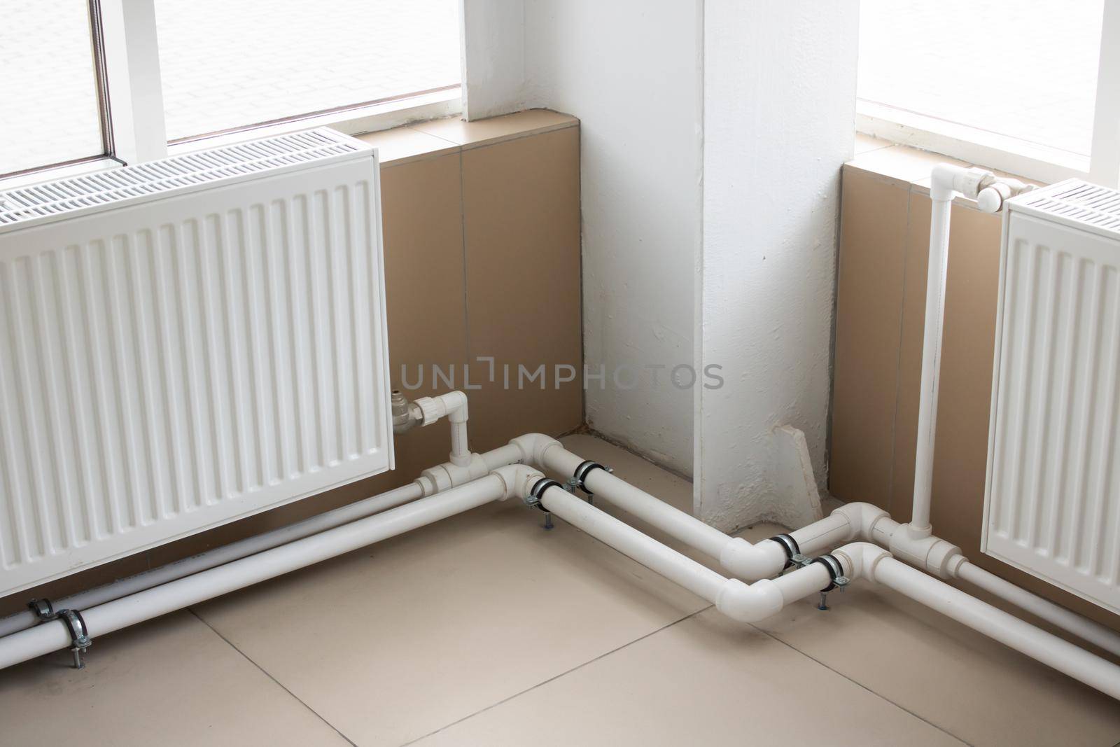 Pipes and radiator by the window close up