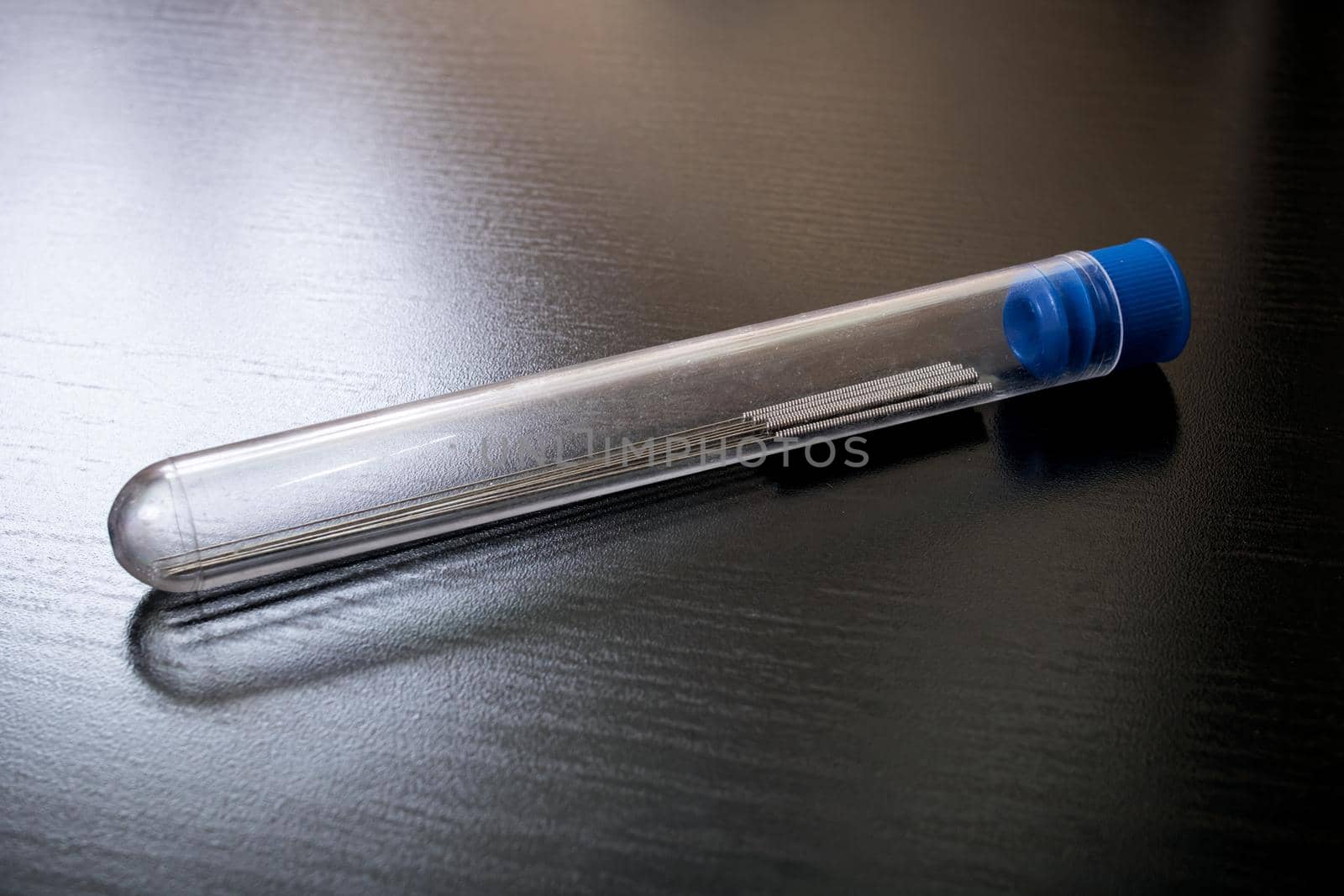 Long thin needles in a test tube close up