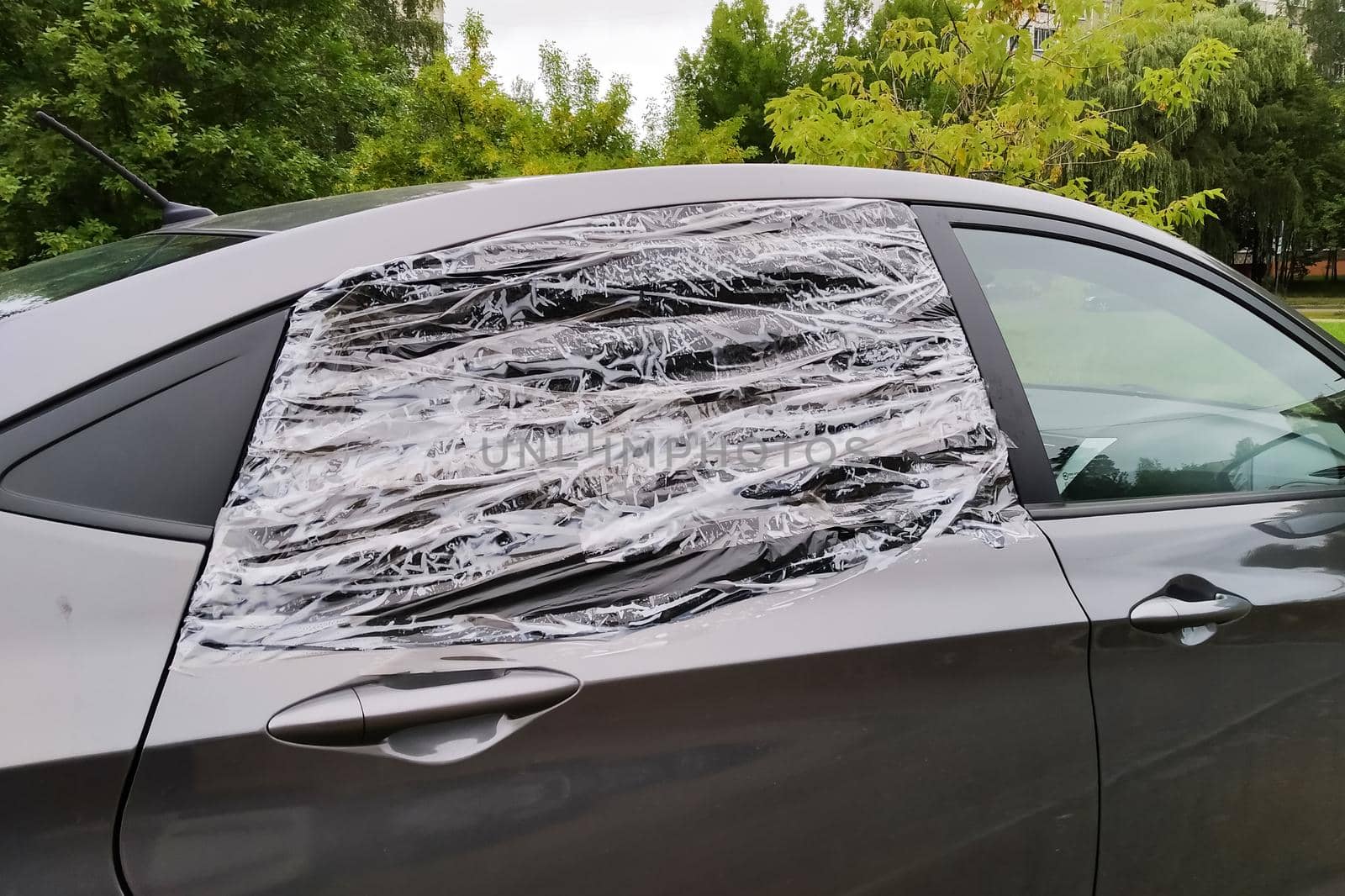 Broken car glass sealed with film close up