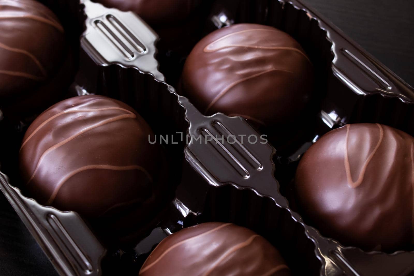 Chocolate candies in a box close up, macro photo