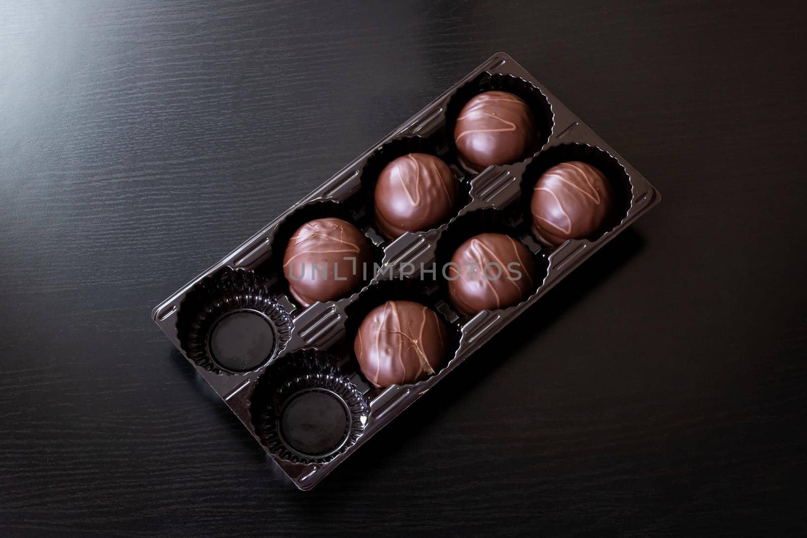 Chocolate candies in a box close up, macro photo