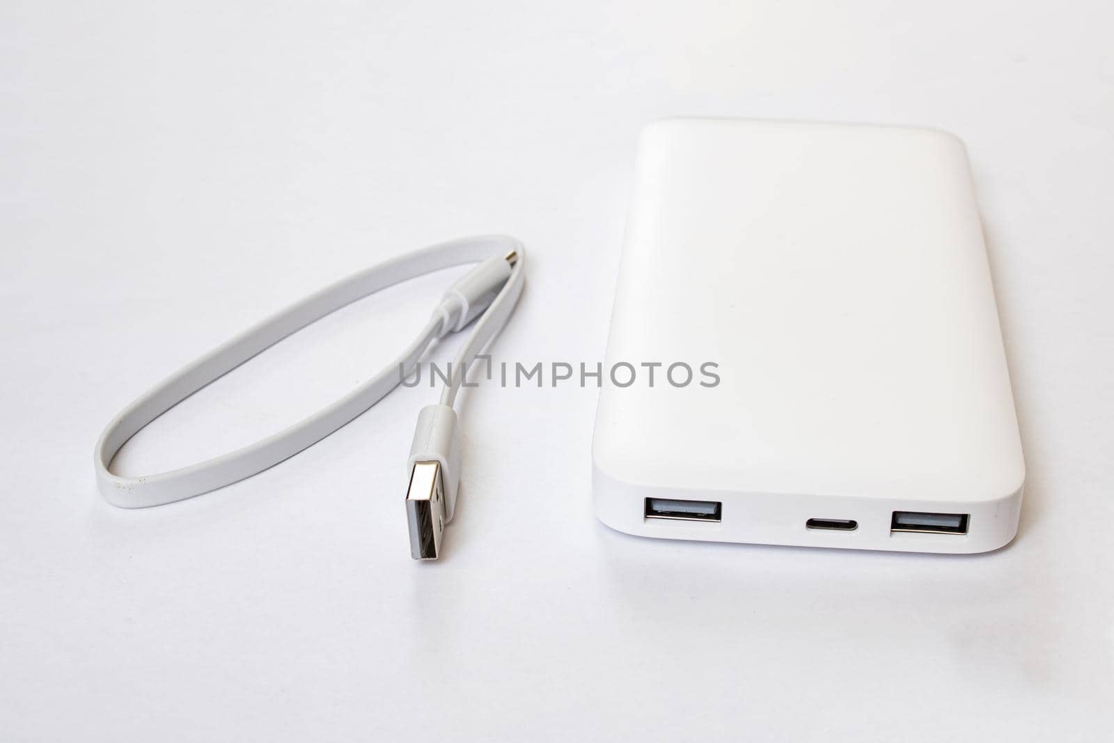 White power bank and cable on white background
