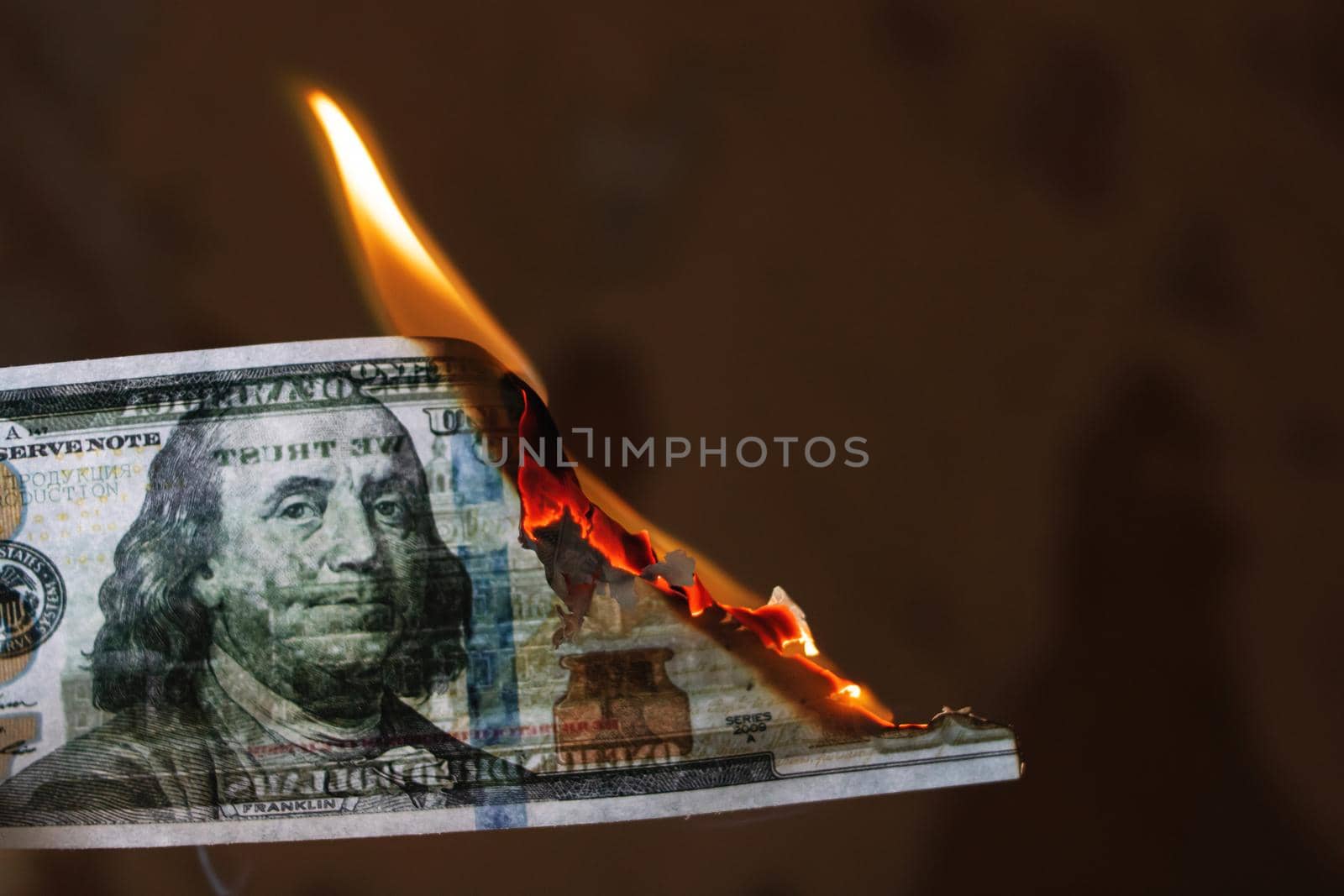 Burning 100 dollar bill close up, copy space
