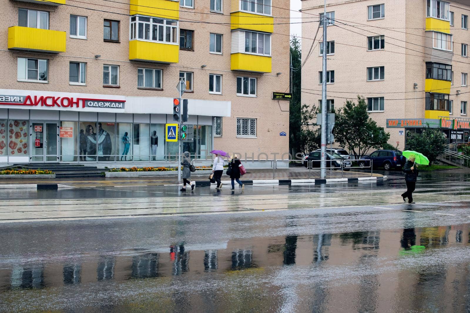 BELARUS, VITEBSK - SEPTEMBER 10, 2020: People at the crosswalk in the rain