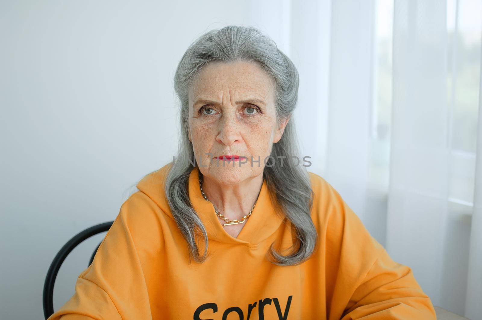 Closeup portrait of angry upset senior mature woman talking with someone and looking at the camera. Negative emotion, facial expression, scandal by balinska_lv