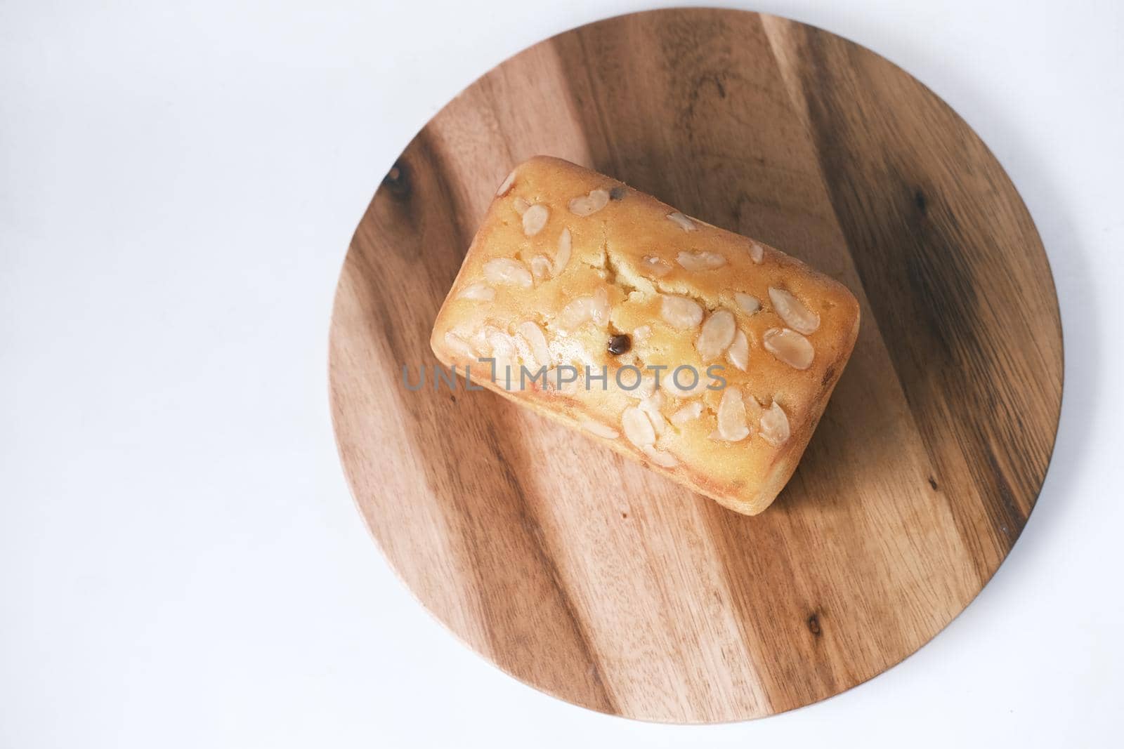 slice of bakery fruit cake on chopping board ,