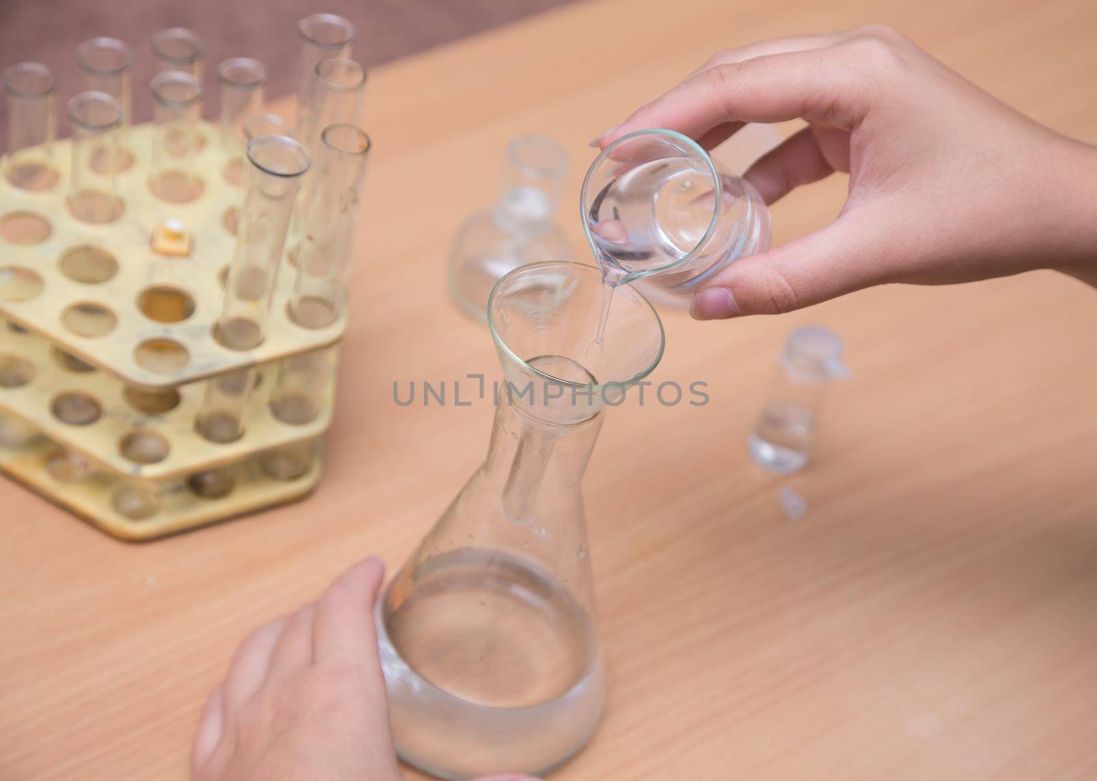 Close-up of a student's hand doing a chemical experiment. A schoolboy performs a task at the workplace. The concept of children's education, teaching knowledge, skills and abilities.