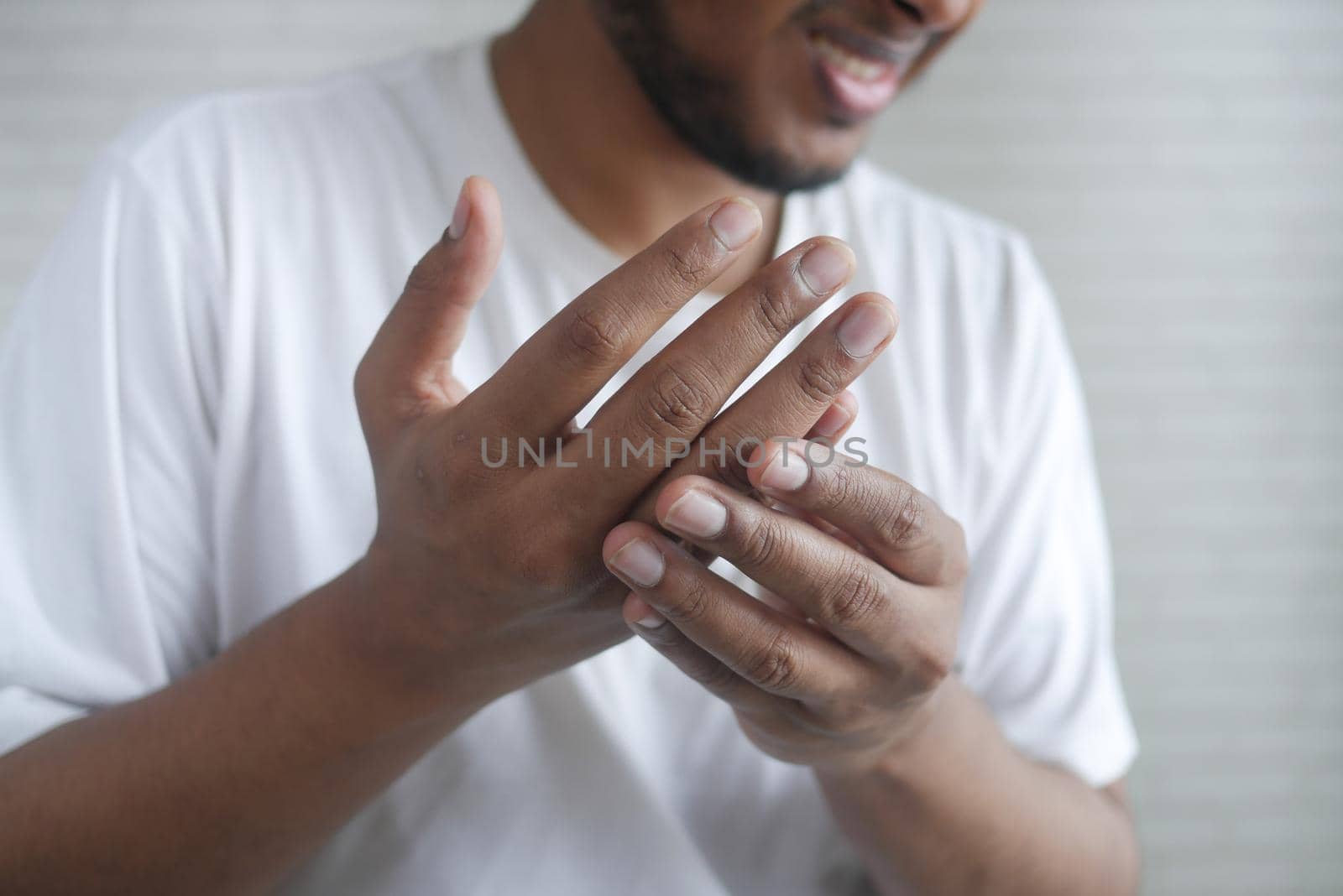 man suffering pain in hand close up .