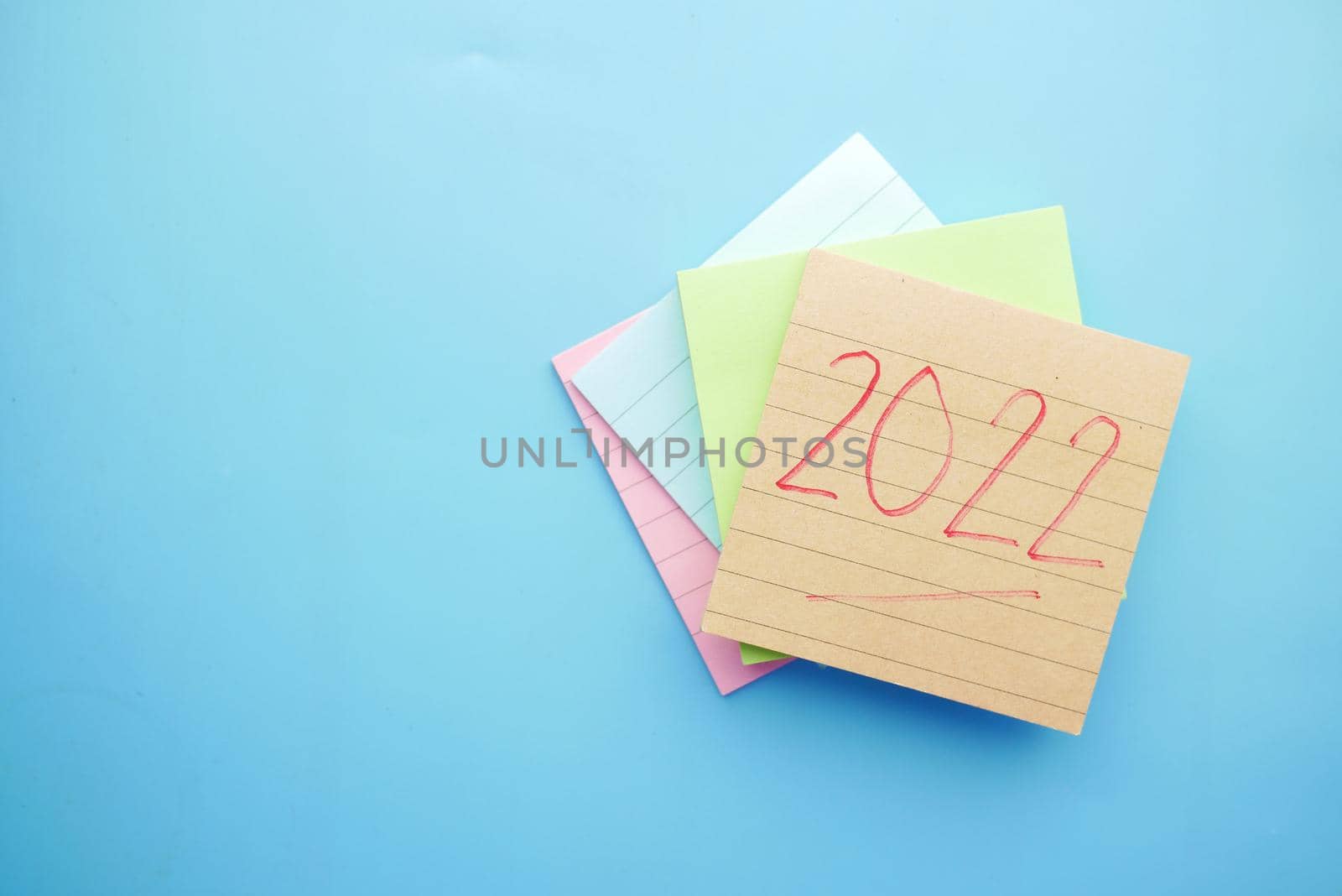 2022 new year goals on sticky notes on blue .