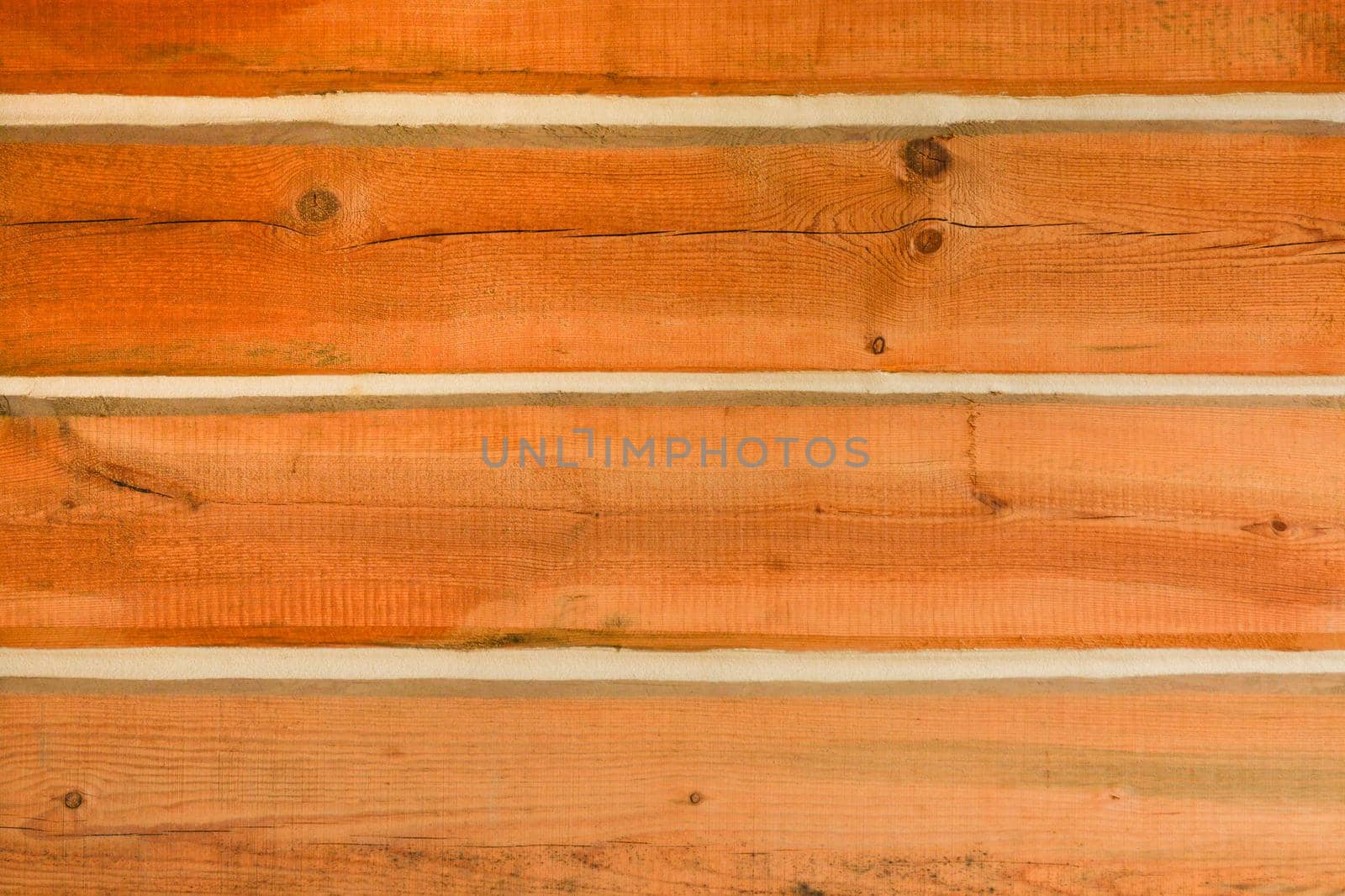 Wooden log wall texture background. Wall of a house built with timber bars