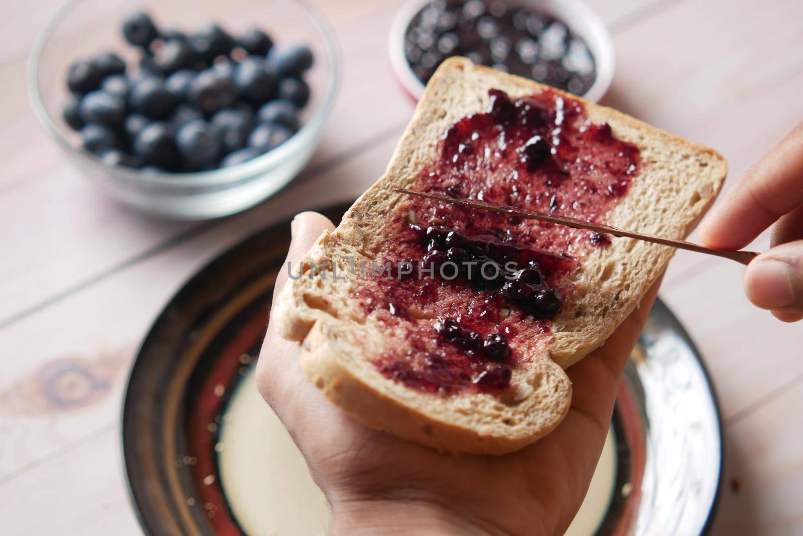 blue berry jam on bread on table