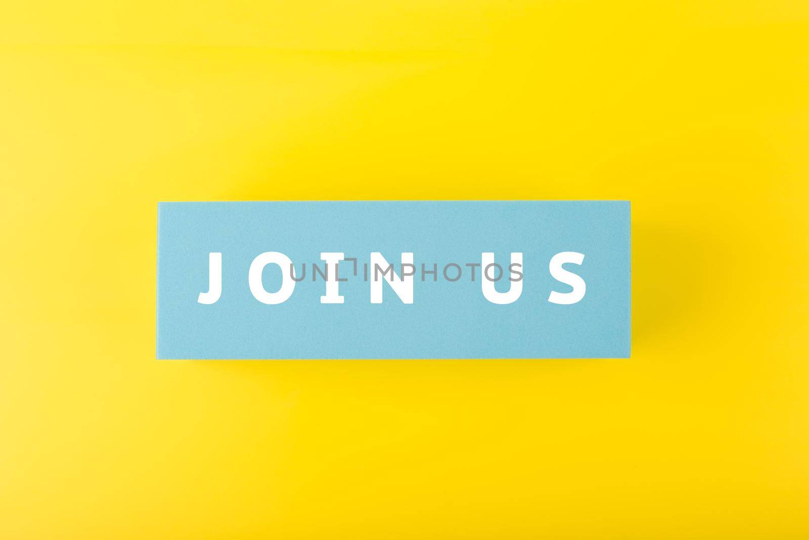 Trendy minimal job opening or headhunting concept. Join us written on blue rectangle against yellow background