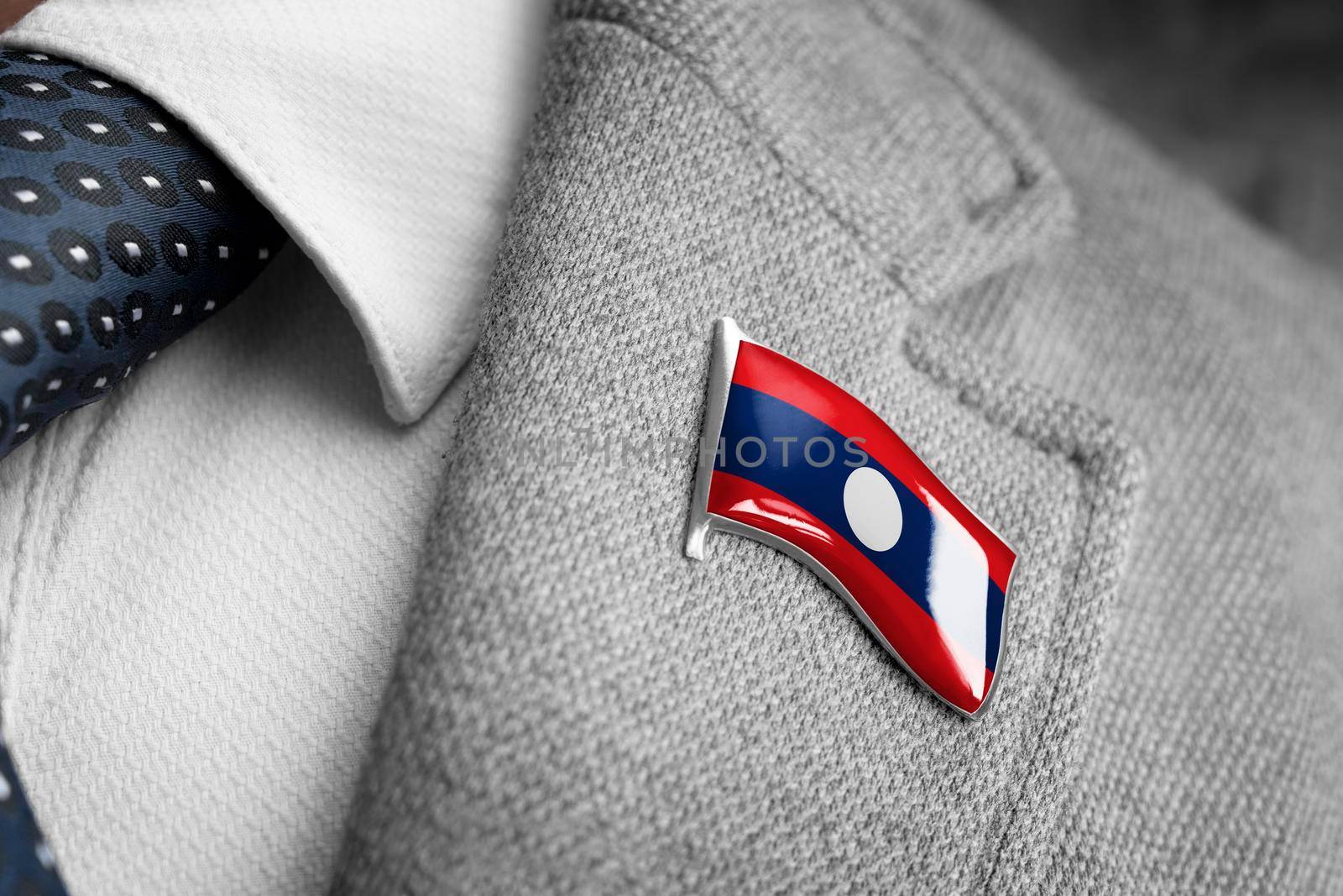 Metal badge with the flag of Laos on a suit lapel.
